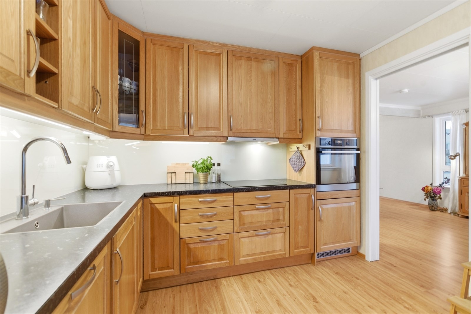 Moderne integrerte hvitevarer. Kjøl/fryseskap, oppvaskmaskin, induksjonstopp, og stekeovn i en praktisk høyde. Galleribilde