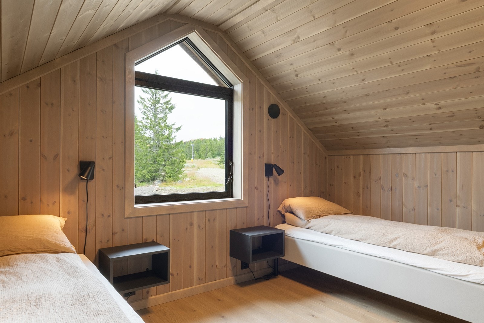 Hytten er i en gjennomført stil med pen enstavs parkett på gulv og panel på vegg. Galleribilde