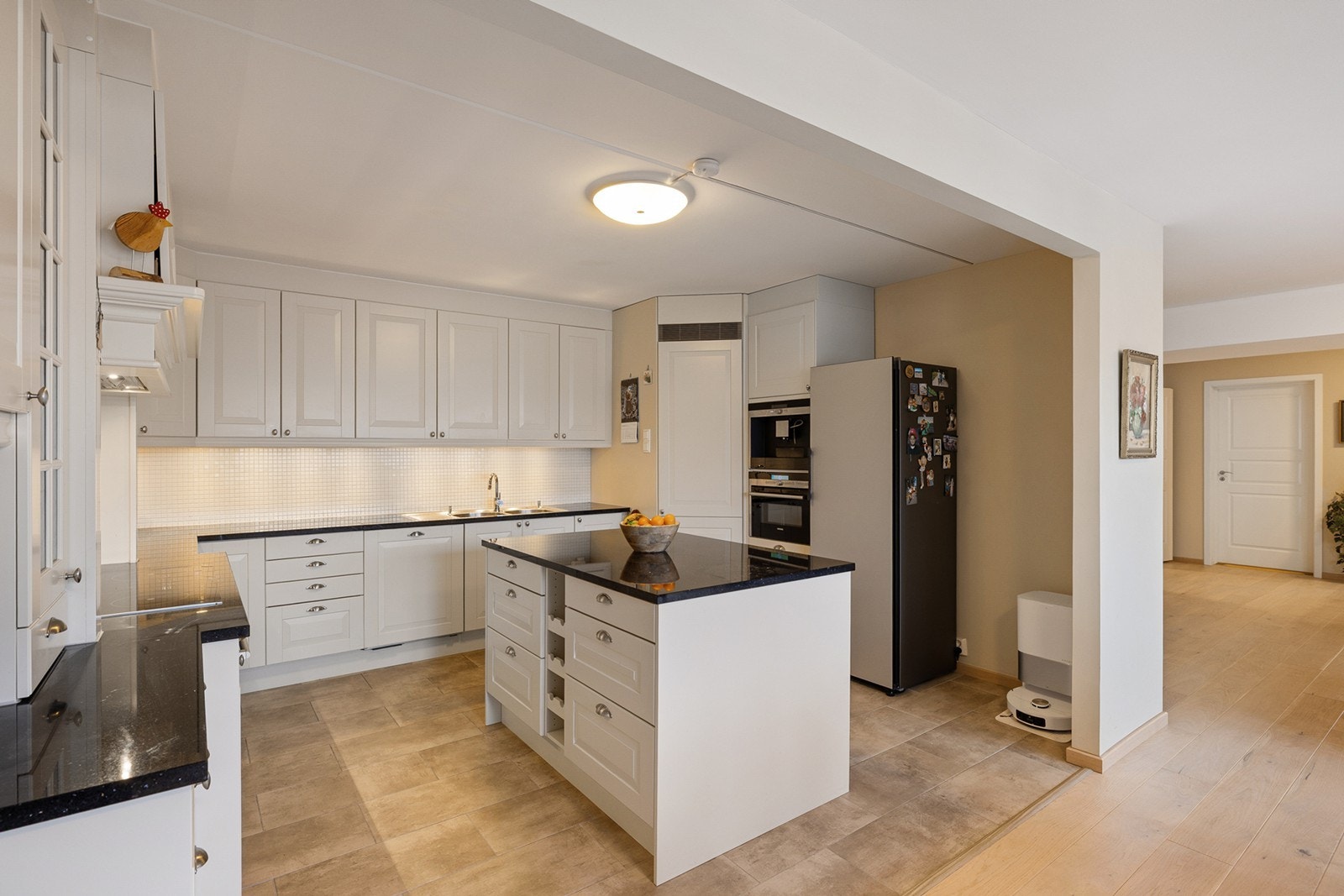 Integrerte hvitevarer består av oppvaskmaskin, hjørnekjøleskap, komfyr og nedfelt platetopp og det er tilkoblet en ventilator over kokeplass. Galleribilde