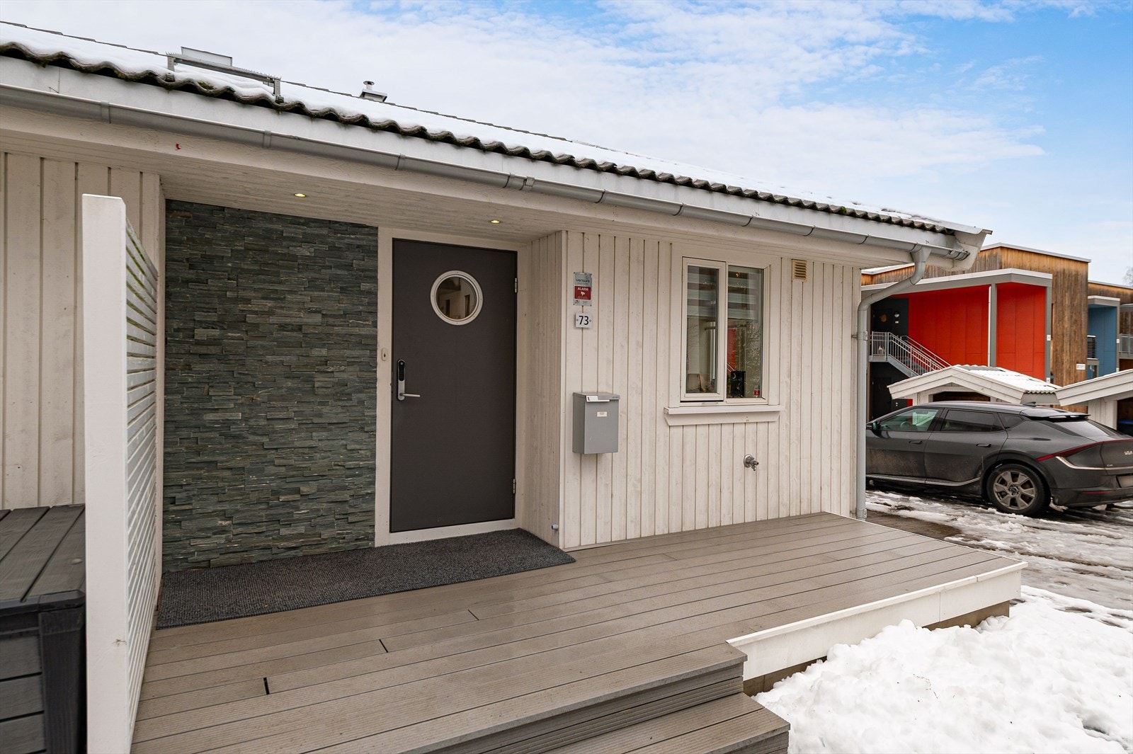 Pent inngangsparti med terrasseplatting mot vest. Yale doorman montert på ytterdør. Galleribilde