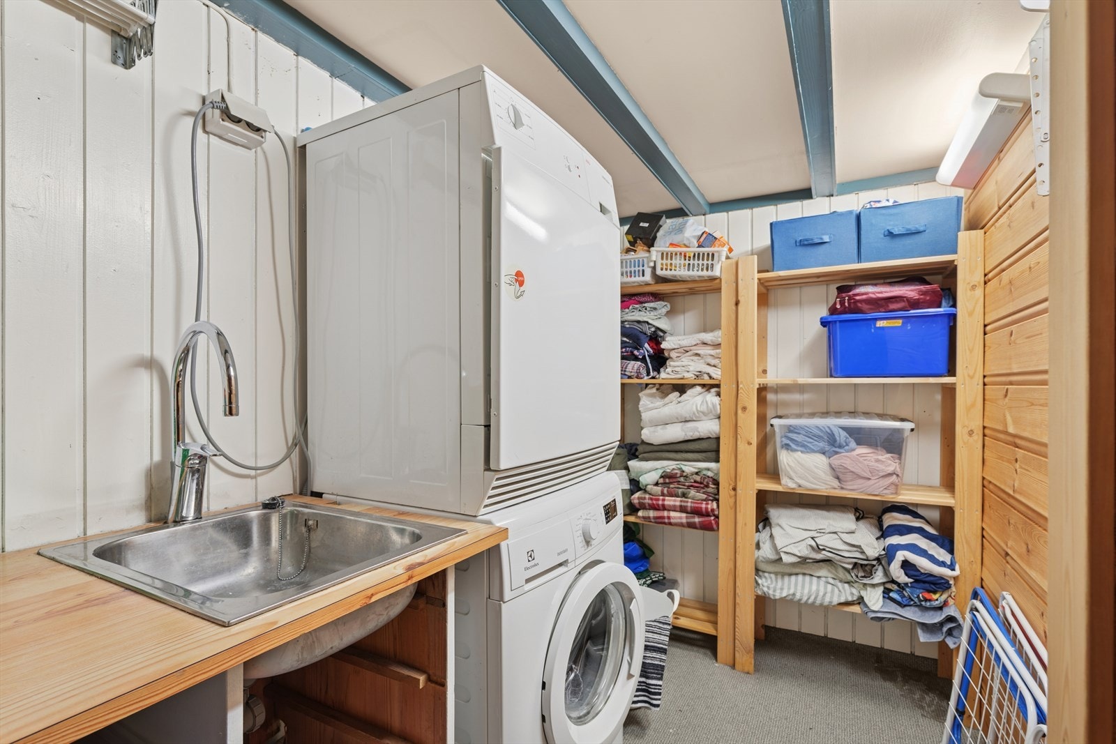 Vaskerommet har panel på veggene og vinylbelegg på gulvet. Det er naturlig ventilasjon og opplegg for vaskemaskin. Galleribilde