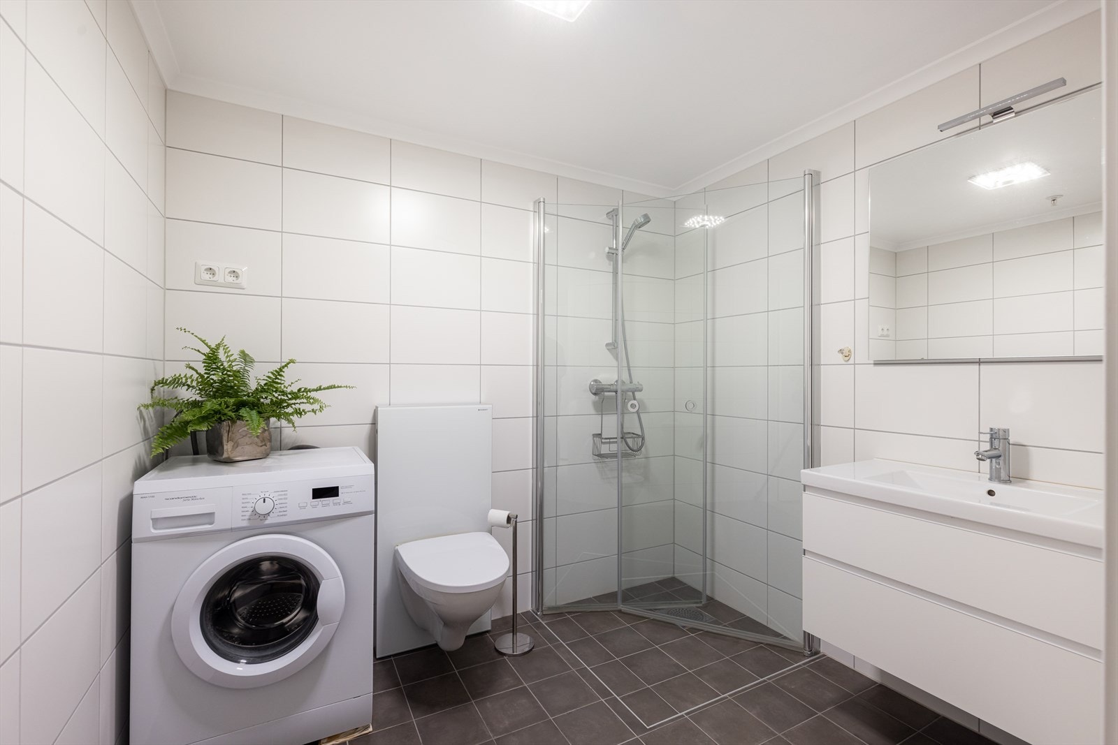 Leilighetens bad er helfliset med varmekabler i gulvet. Galleribilde