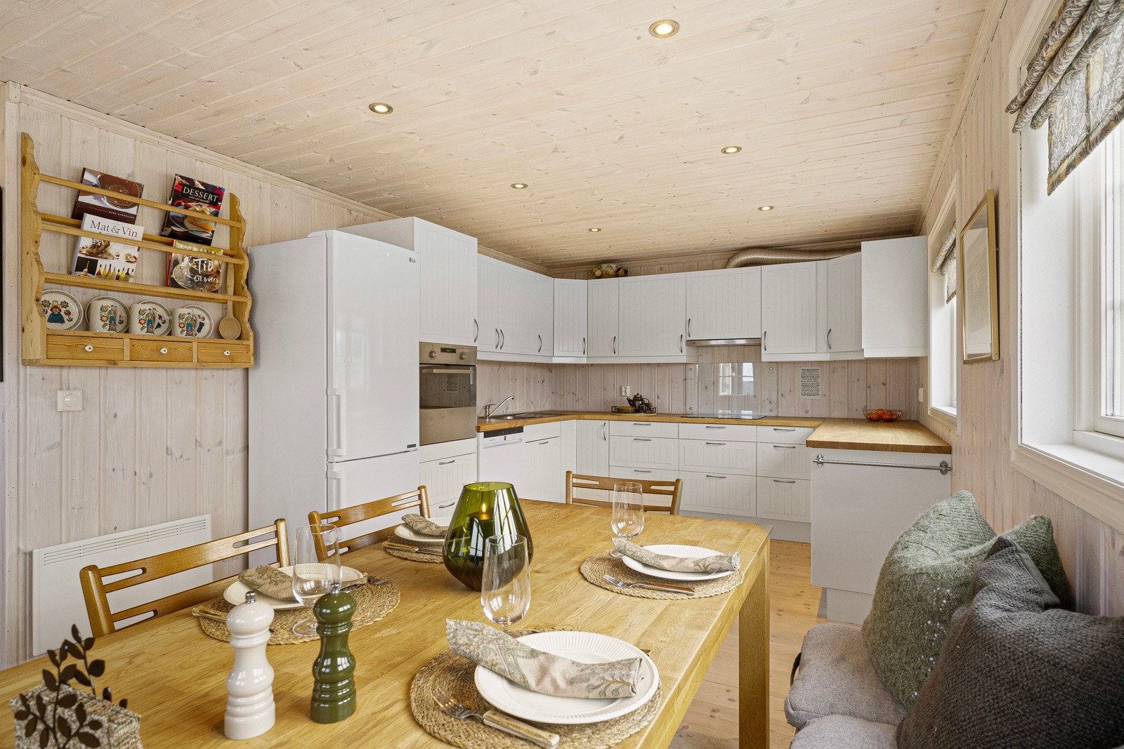 Kjøkkenet har innredning fra byggeår, med hvite profilerte fronter, under- og overskap Galleribilde