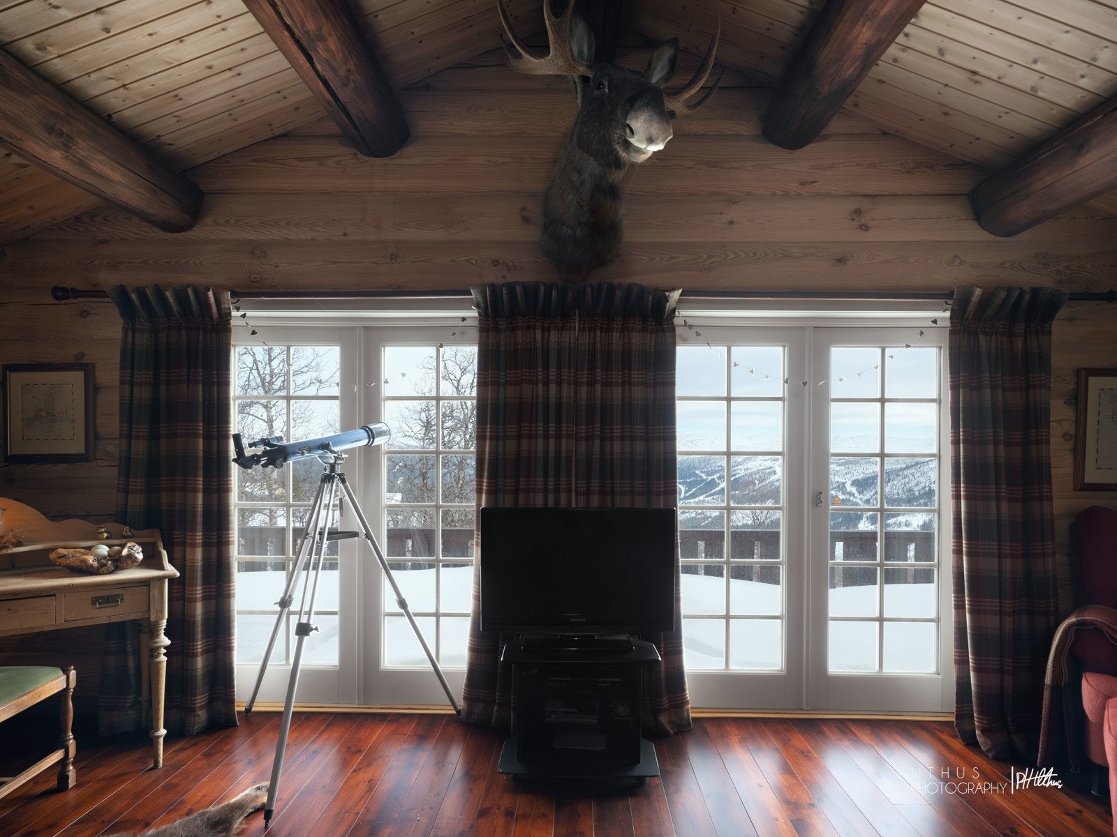 Hytta er oppført i 8" solid tømmer - Synlige åser og røstet himling gir den gode hyttefølelse fra man går inn i stuen Galleribilde