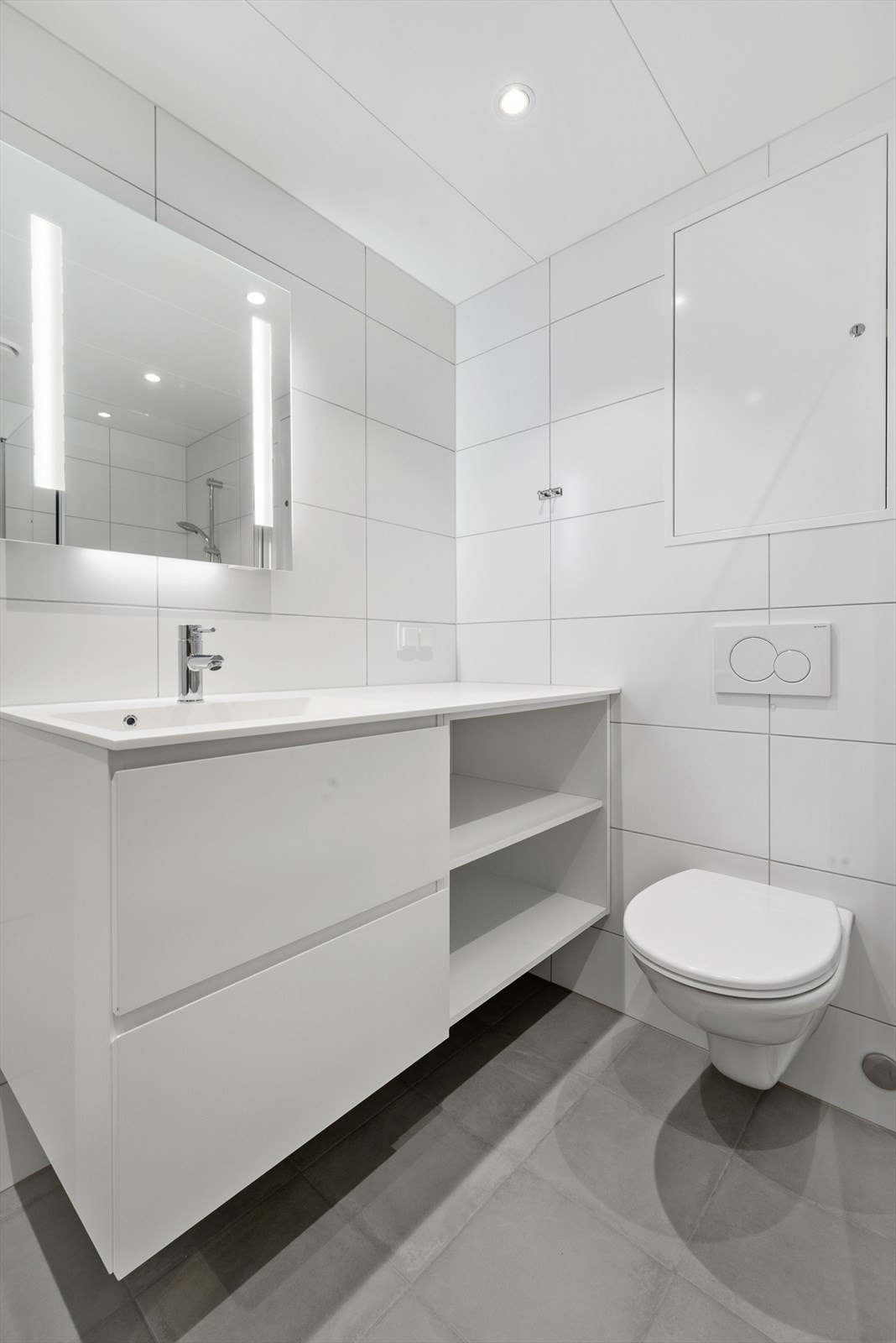 Videre byr badet på en pen, lys innredning med heldekkende servant med skuffer og hyller under, samt vegghengt speil med integrert belysning. Galleribilde