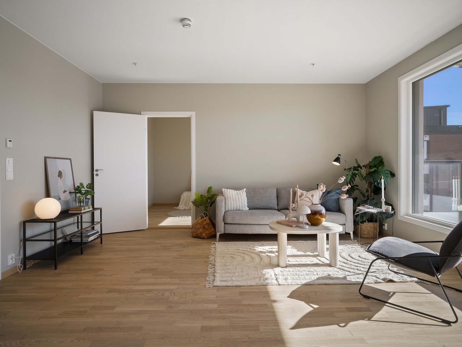 Romslig og lys stue og kjøkken med store vinduer som gir rikelig dagslys Galleribilde