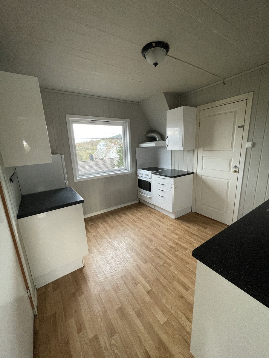 Kjøkken med flere arbeidssoner og mye benkplass Galleribilde