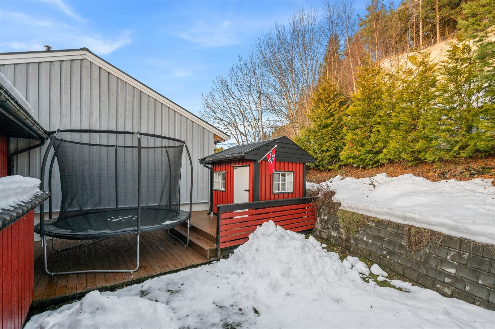 Romslig hage med plass til både trampoline og dukkestue Galleribilde