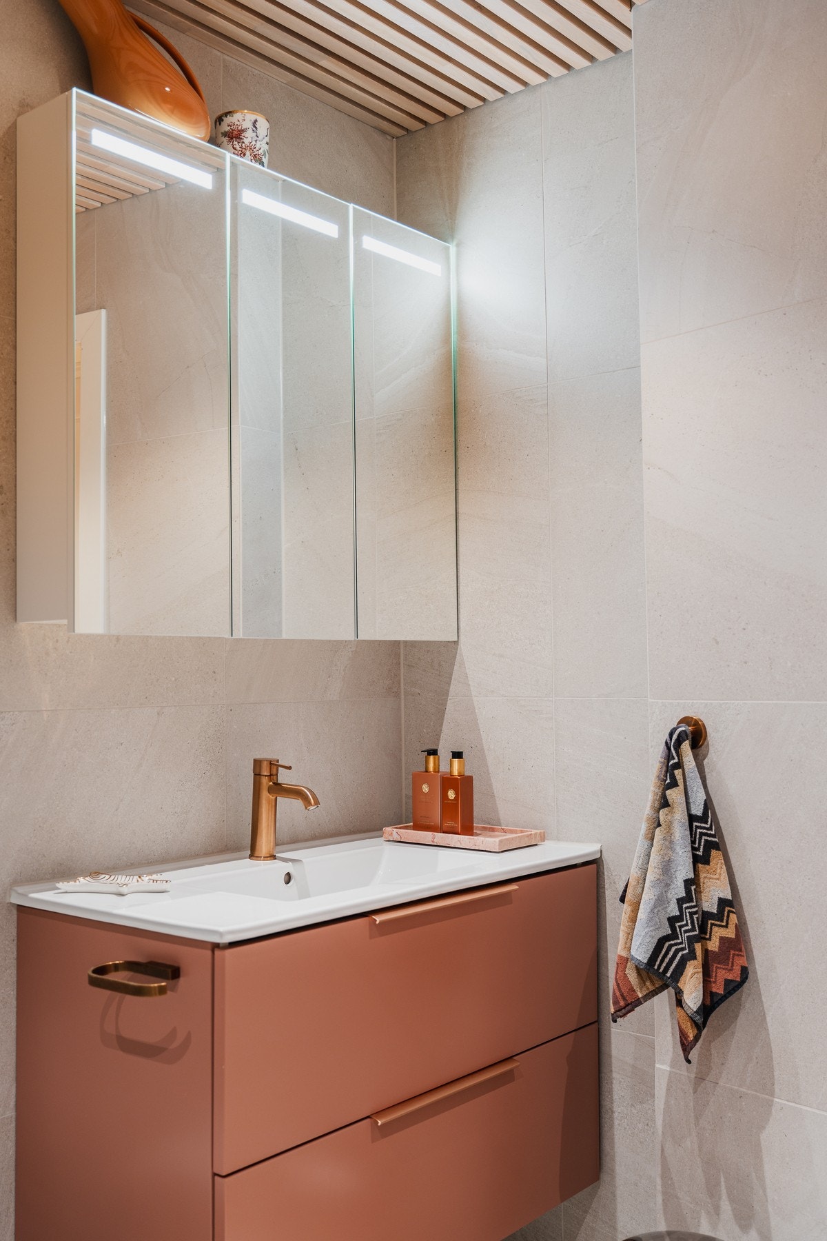 Armatur i dusj og servant, toalettrullholder og spyleknapp i matchende bronsefarge. Galleribilde