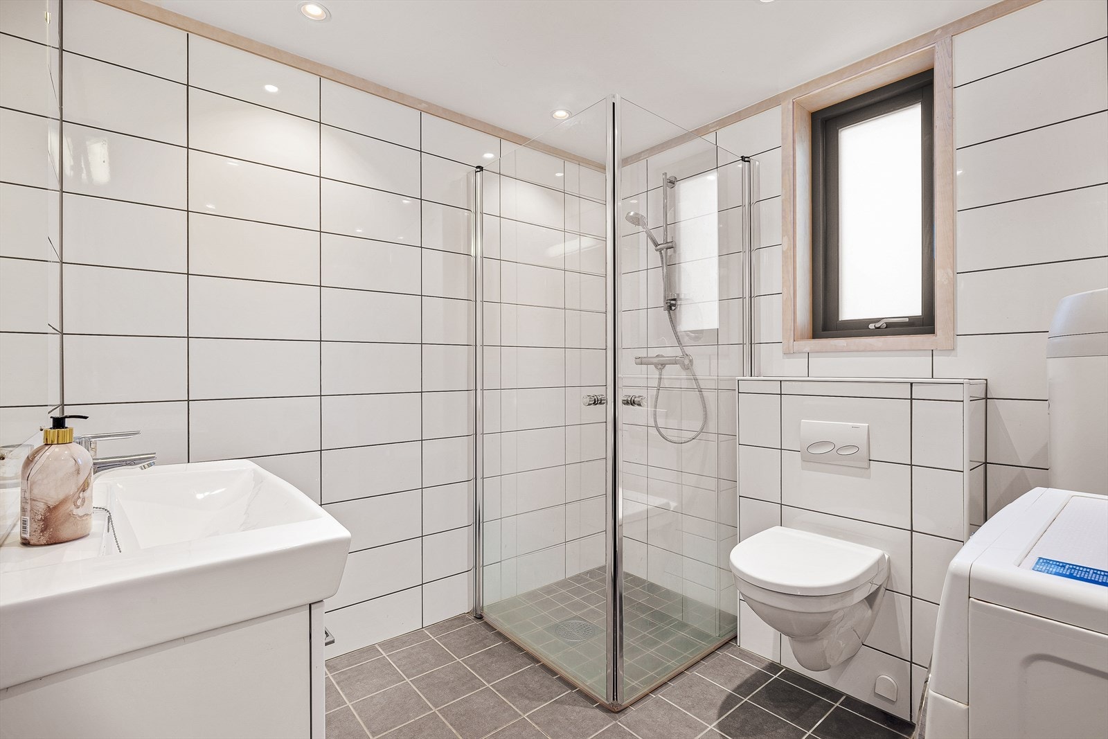 Lekkert, flislagt bad med fliser på gulv og vegger, og vannbåren varme i gulv Galleribilde