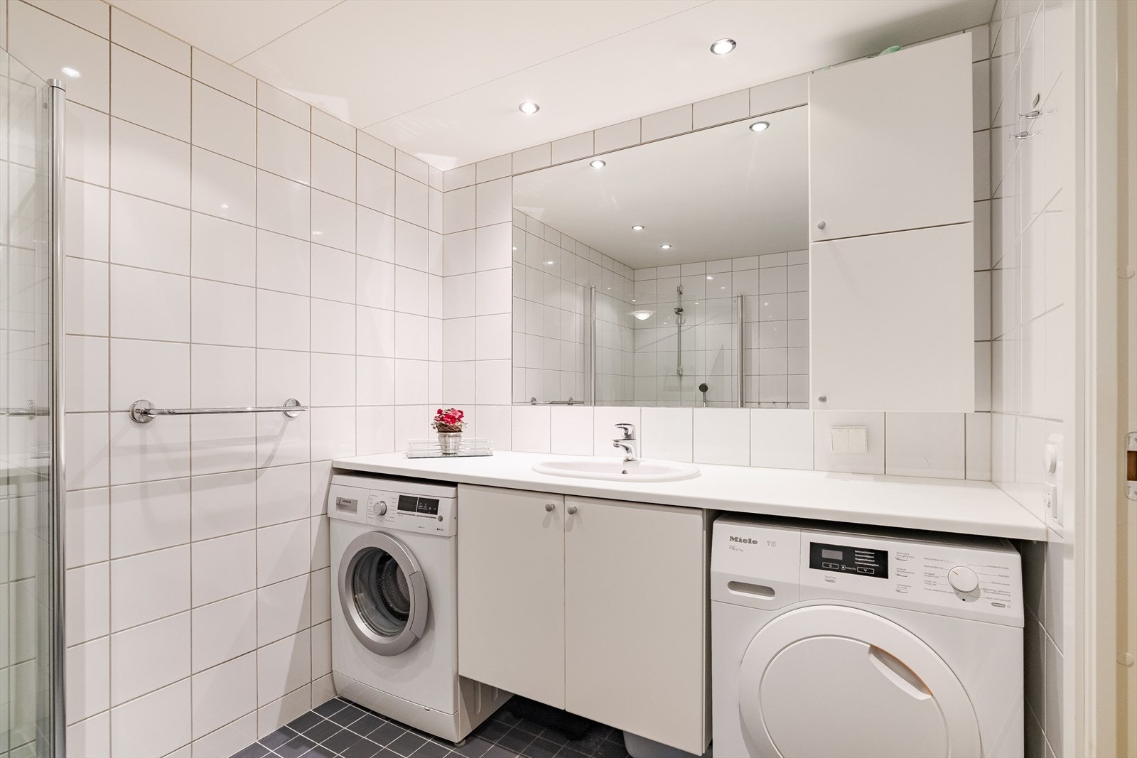 Flott stilrent bad med opplegg til både vaskemaskin og tørketrommel. Galleribilde