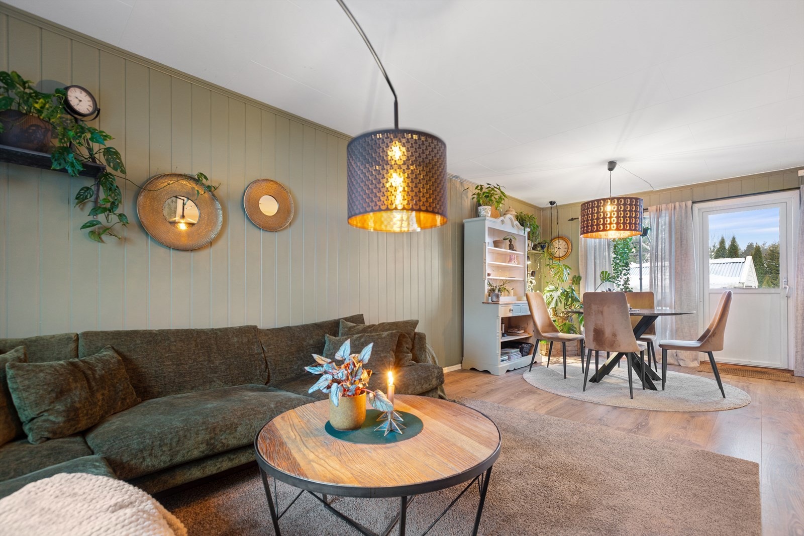 Overflatene er malt i en tidsriktig grønntone, det er peisovn som sørger for varme og laminat på gulv. Galleribilde