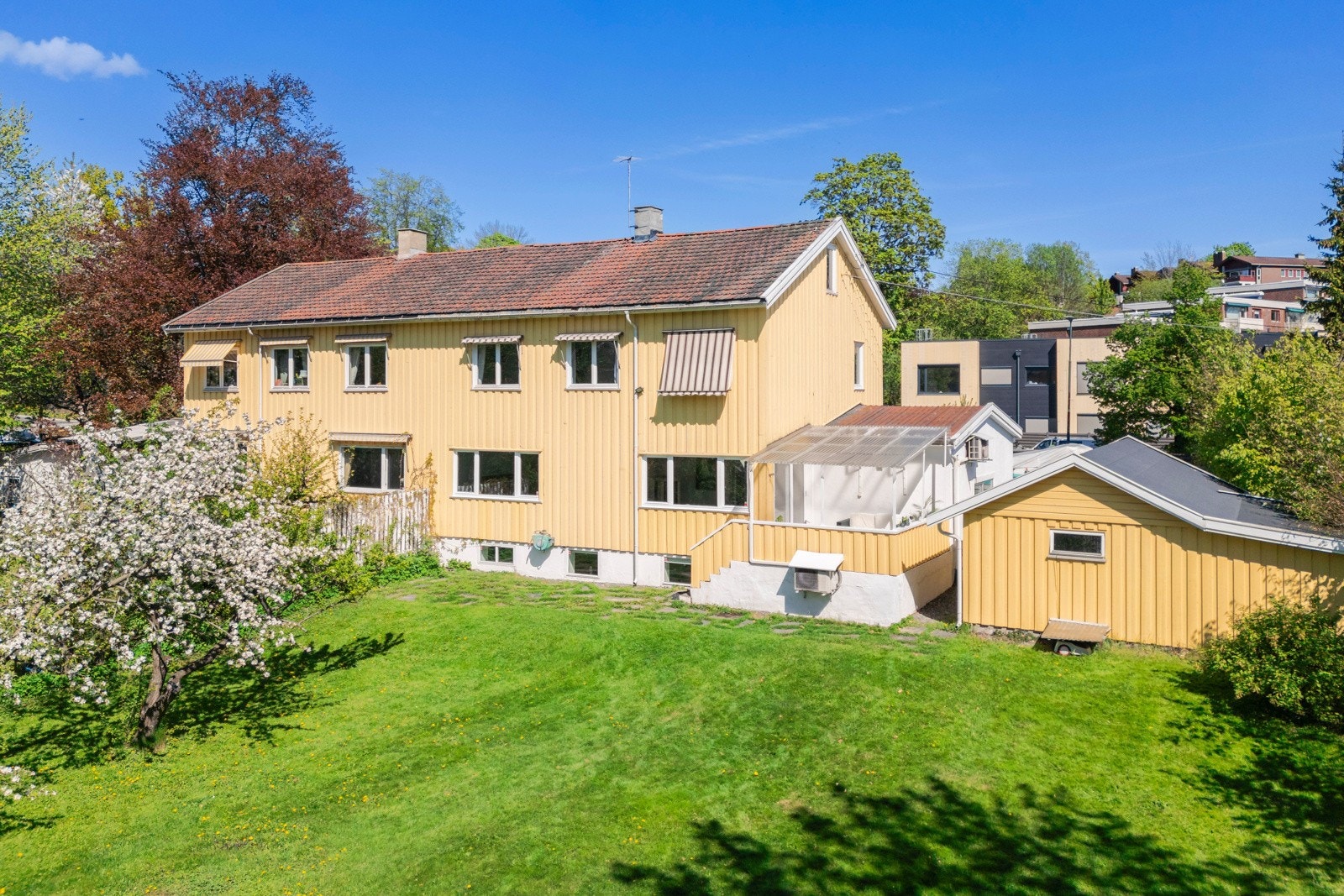 Stor halvpart av tomannsbolig med garasje og stor hage. Galleribilde