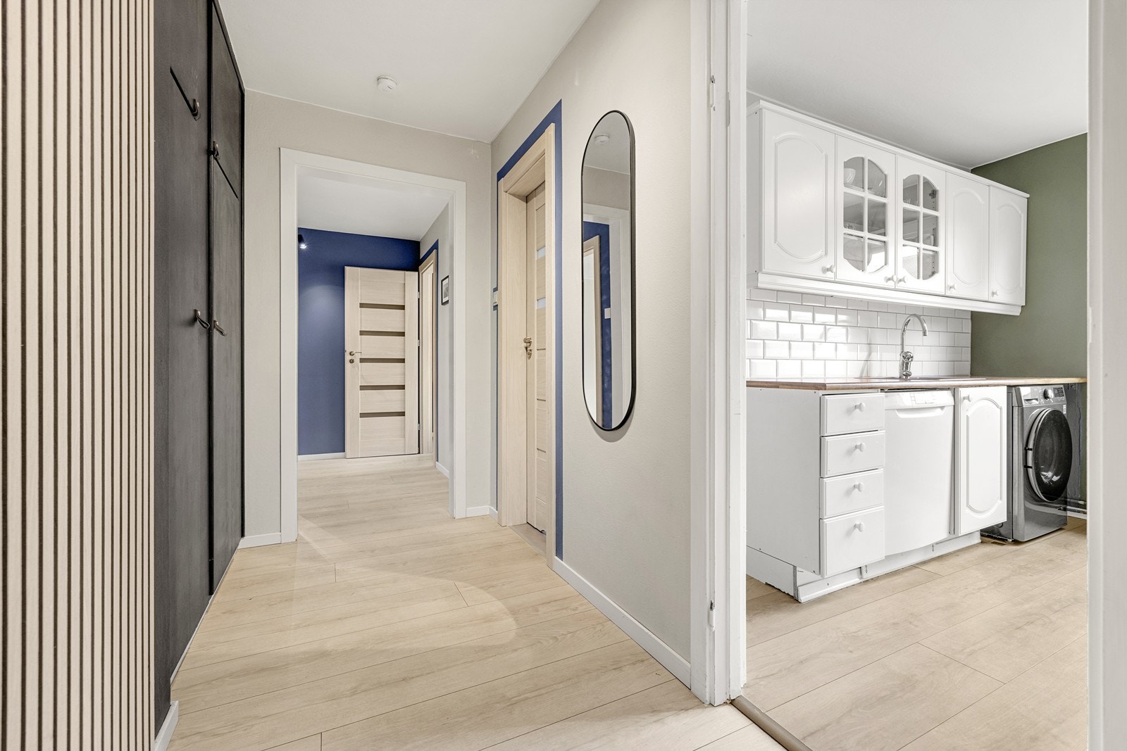 Fra gangen er det en åpen og naturlig overgang til leilighetens kjøkken og øvrige rom. Galleribilde