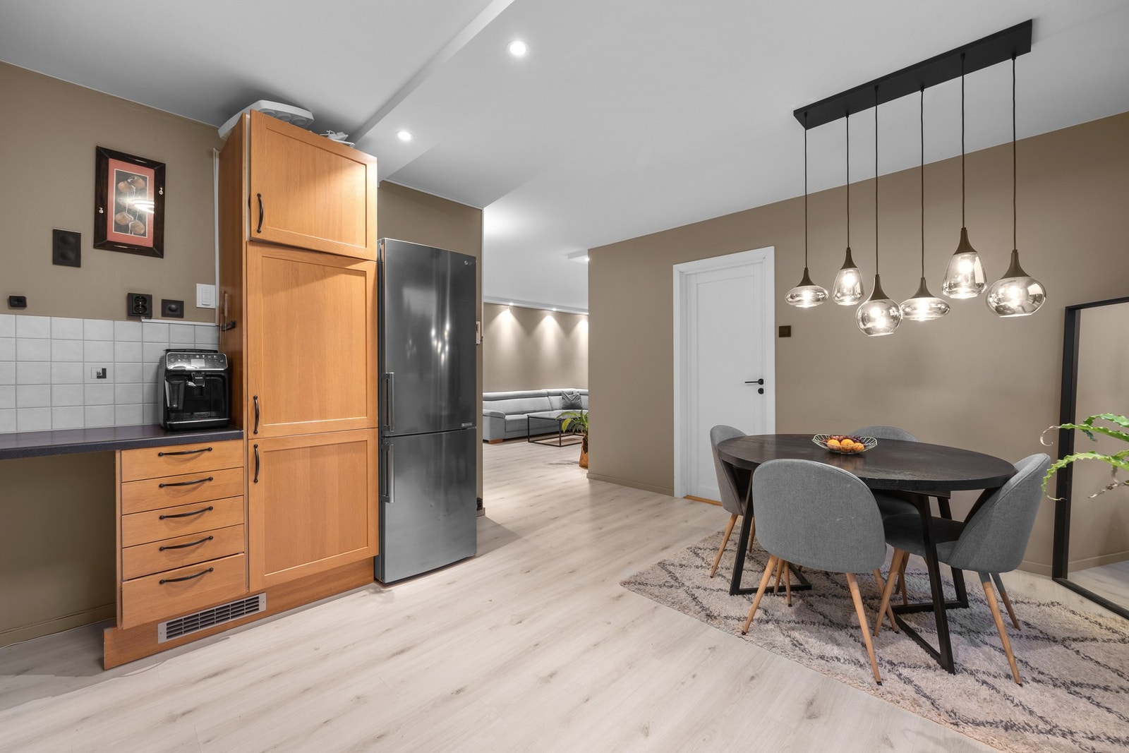 Lun og romslig kjøkkenavdeling med klassiske fronter, integrerte hvitevarer og praktisk spiseplass i tilknytning. God oppbevaring og fliser over benkeplate gjør rommet lett å holde ryddig. Galleribilde