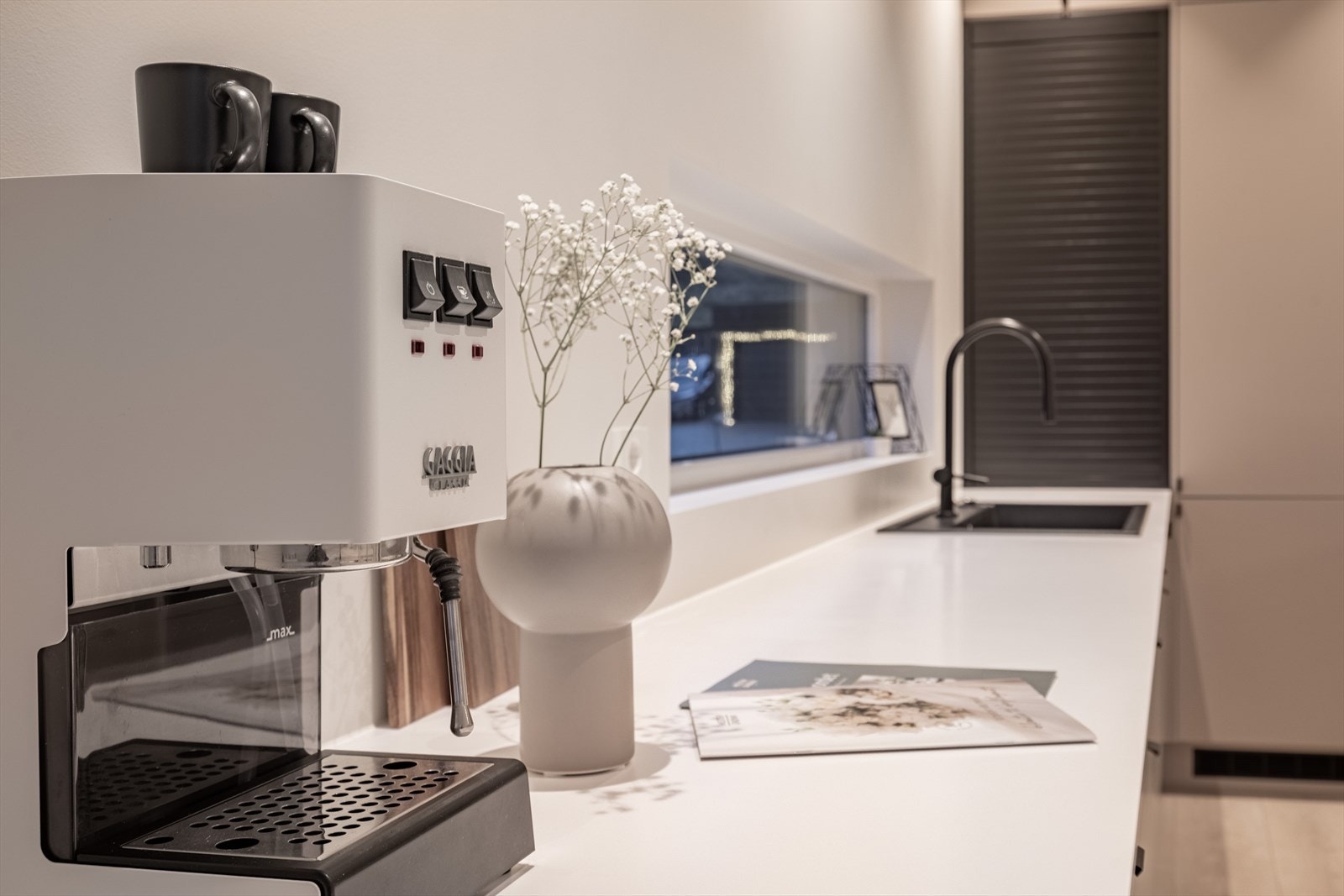 Gjennomført og påkostet kjøkken med moderne, slette fronter, god skapplass, kjøkkenøy med stor platetopp, nedfelt ventilator, integrerte hvitevarer med wifi-styring og integrerte Sonos-høyttalere i himlingen. Galleribilde