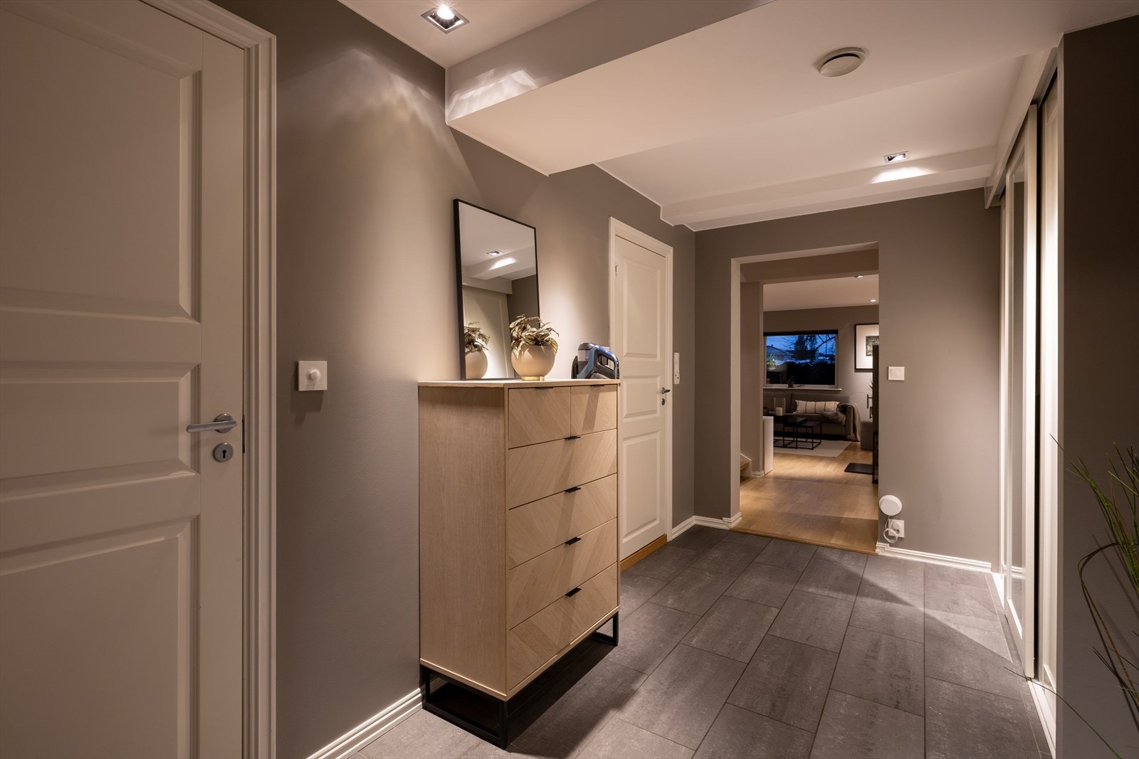 Entréen i boligen er utstyrt med et stort garderobeskap som gir god plass til yttertøy og andre tekstiler. Fra gangen er det direkte tilgang til walk-in garderobe, bad og vaskerom, som gir en svært praktisk løsning i hverdagen. Galleribilde