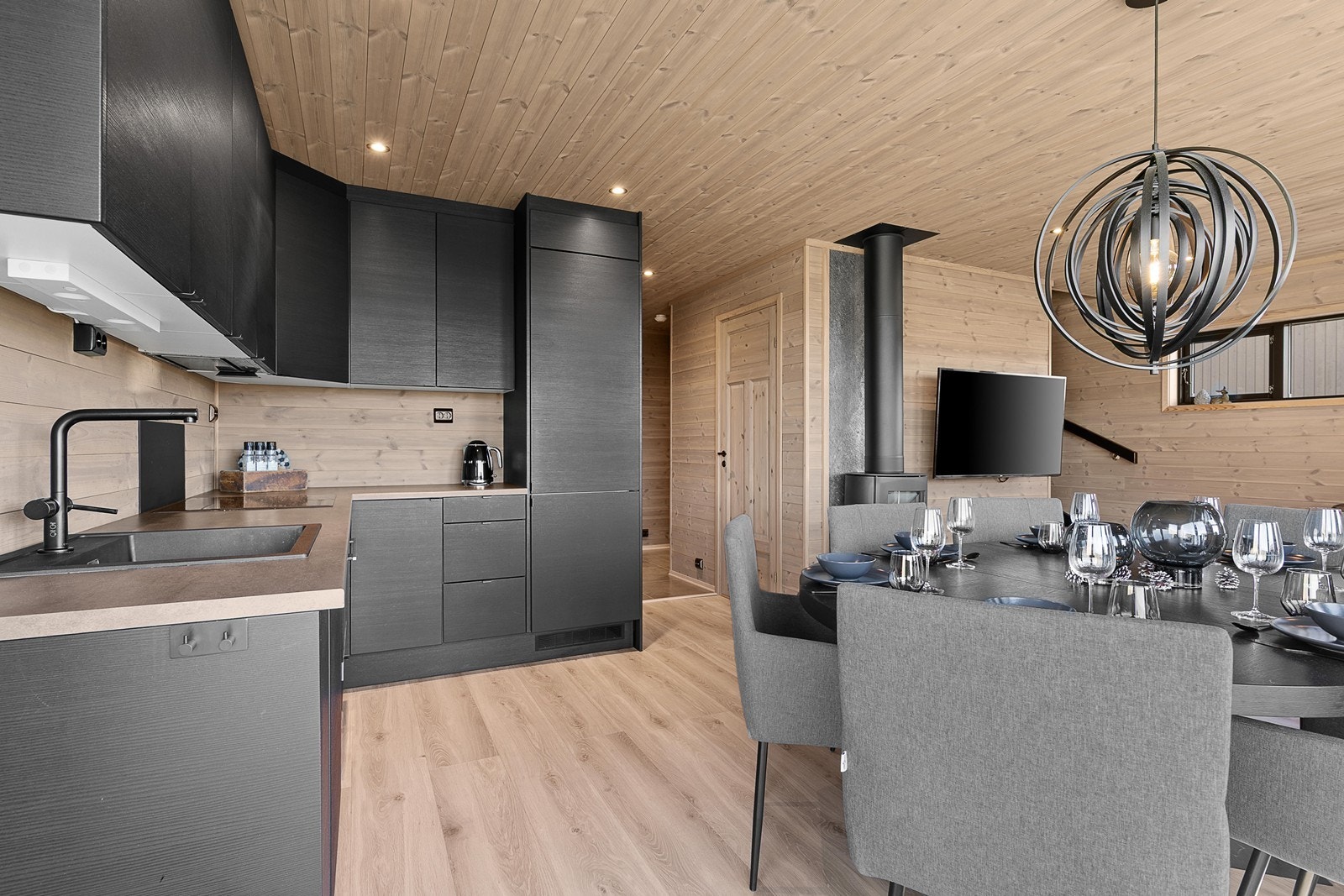 Kjøkkenet er utformet i en praktisk L-løsning som gir god arbeidsflate og effektiv utnyttelse av rommet, samtidig som den åpne løsningen gjør det enkelt å være sosial og delta i selskapet mens maten tilberedes. Galleribilde