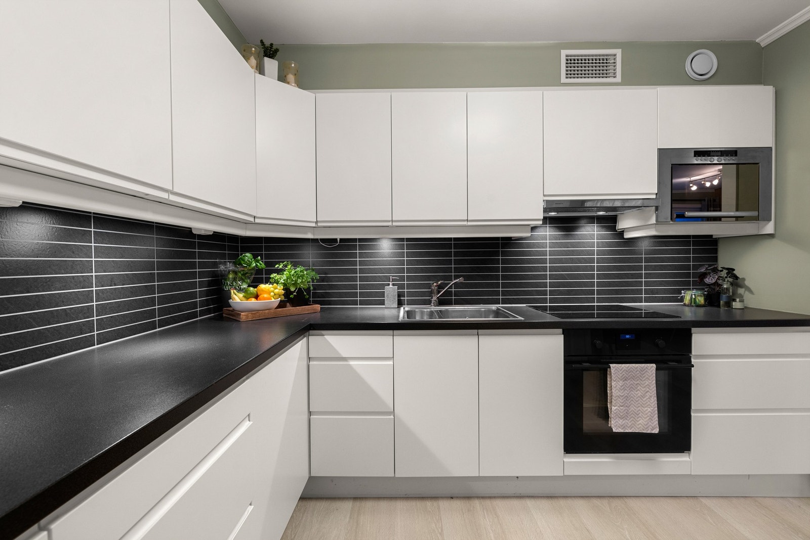 Kjøkkenet har mye skap og benkplass. Inneholder oppvaskmaskin, platetopp, stekeovn og mikrobølgeovn. Galleribilde