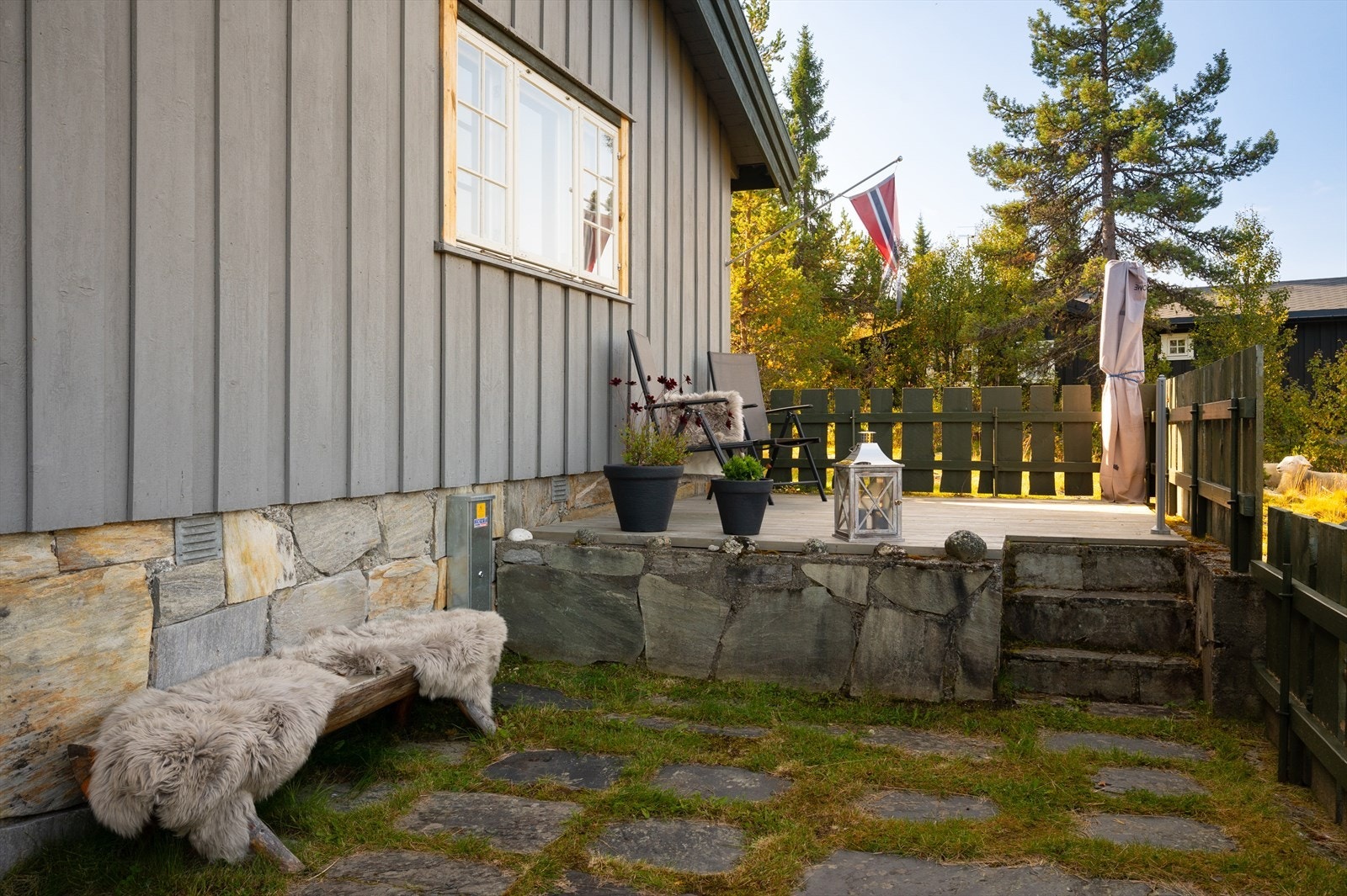 Terrasse har 2 nivåer , der den nederste er med steinheller. Galleribilde