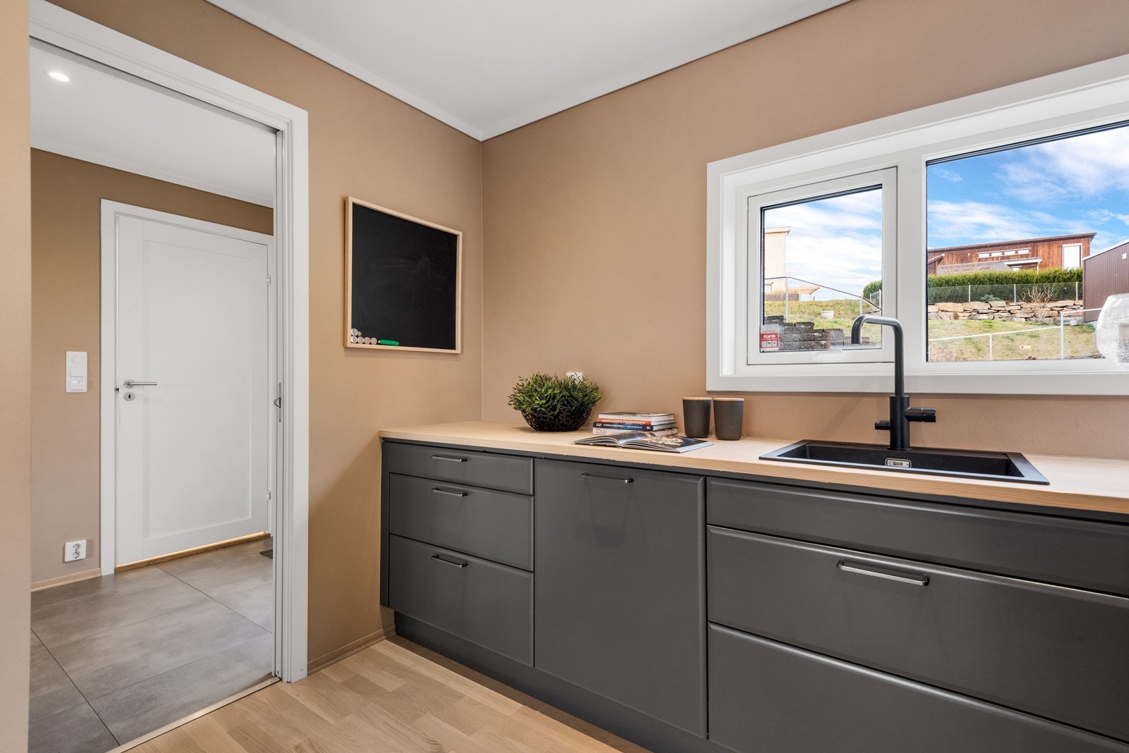 Fra kjøkkenvinduet er det hyggelig utsyn mot nabolaget. Galleribilde