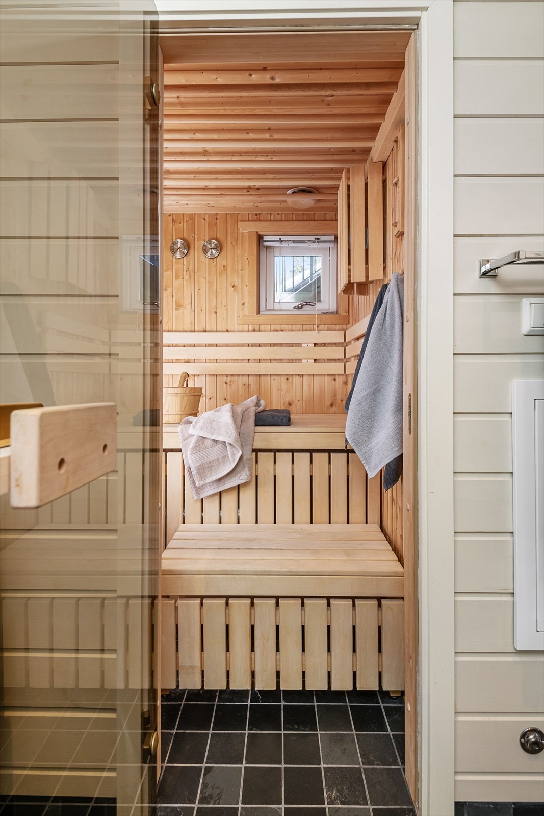 I tilknytning til badet er det en romslig badstue med sotet glassdør plassbygd benk og elektrisk badstuovn. Galleribilde