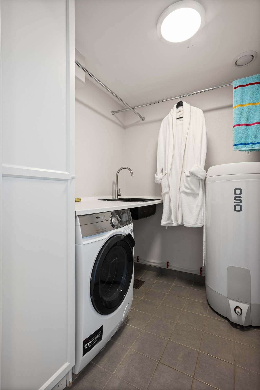 Vaskerom har adkomst fra kjøkken. Her har man opplegg for vaskemaskin, utslagskum og varmtvannsbereder. Galleribilde