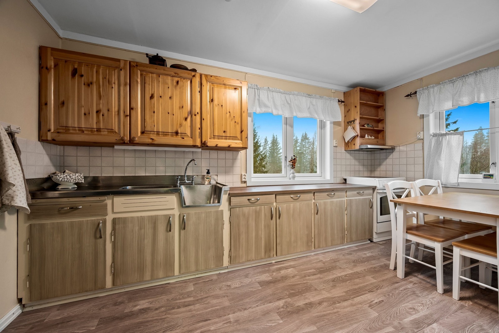 Kjøkken med god skapplass. Malte fronter på underskap. Overskap laget av møbelsnekker. Galleribilde