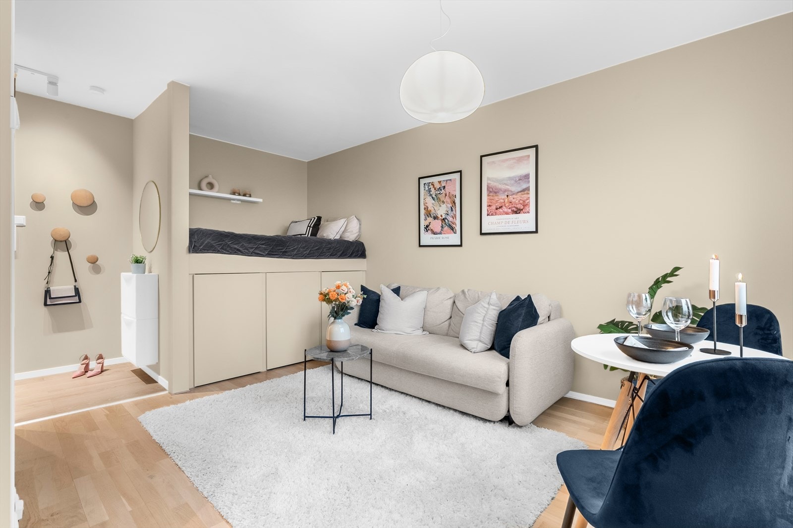 Stue med praktisk alkoveløsning med plassbygd seng, smarte oppbevaringsløsninger og gjennomgående delikate fargetoner. Galleribilde