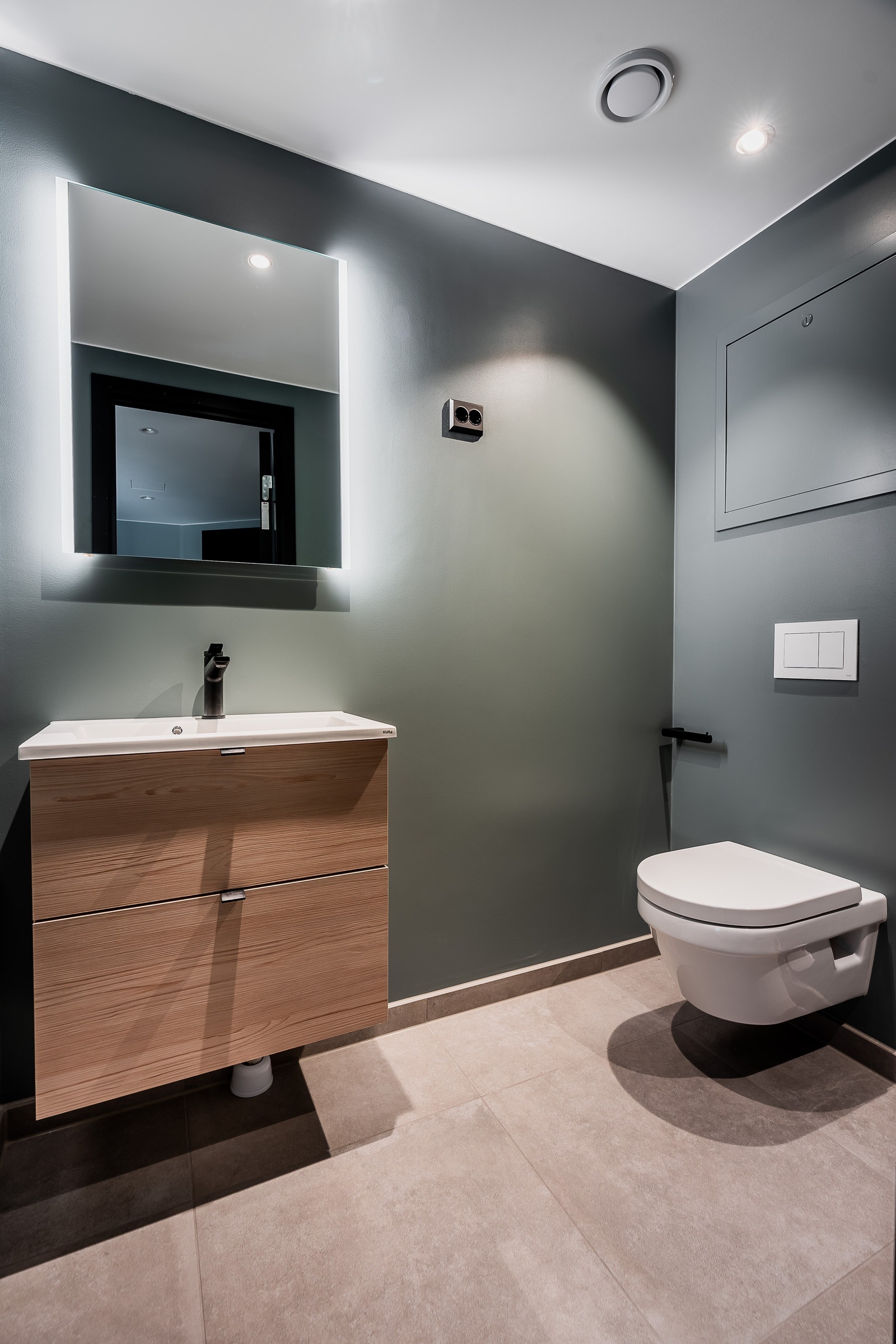 Baderommet i behagelige og varme farger med sorte, røffe detaljer. Galleribilde