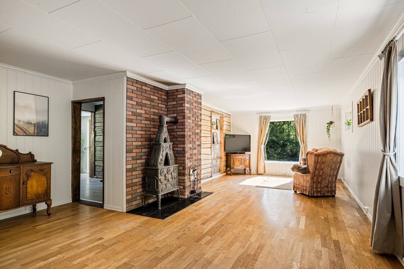 Romslig stue med store vindusflater og plass til både sofa- og spisegruppe. Galleribilde