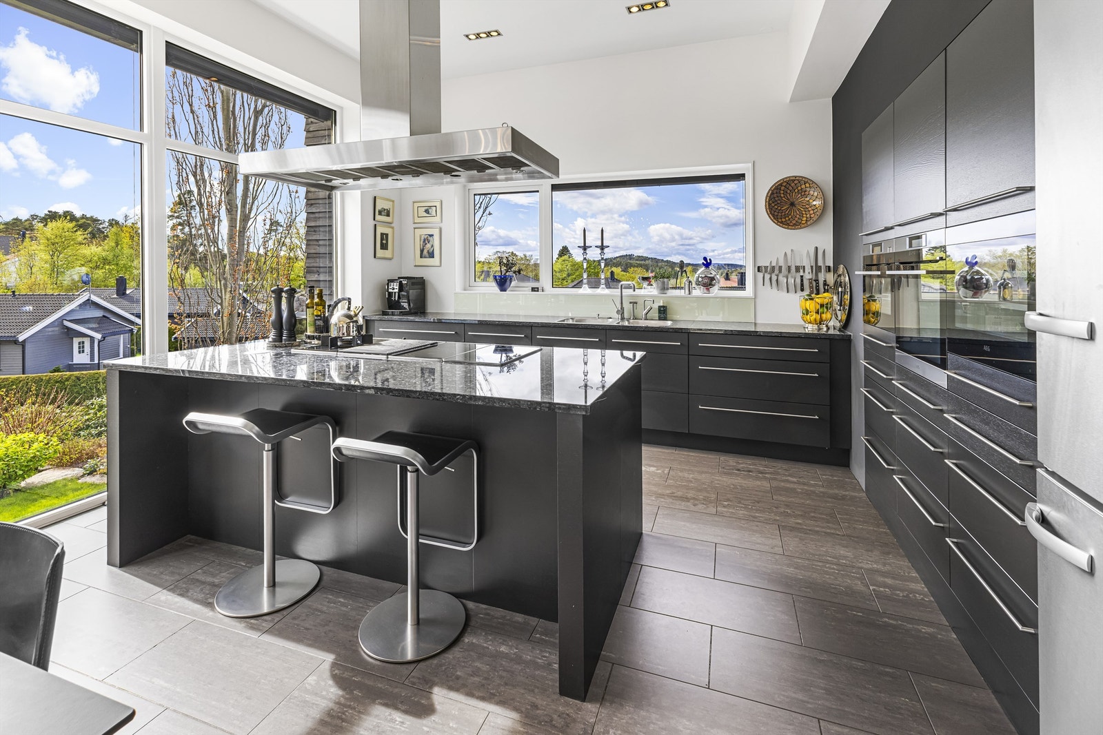 Innholdsrikt og pent kjøkken. Innredningen er av god kvalitet med integrerte hvitevarer og benkeplate av stein. Galleribilde