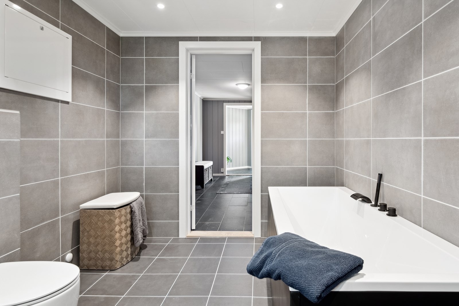 Pent flislagt baderom fra 2025 med gulvvarme og downlights. Galleribilde