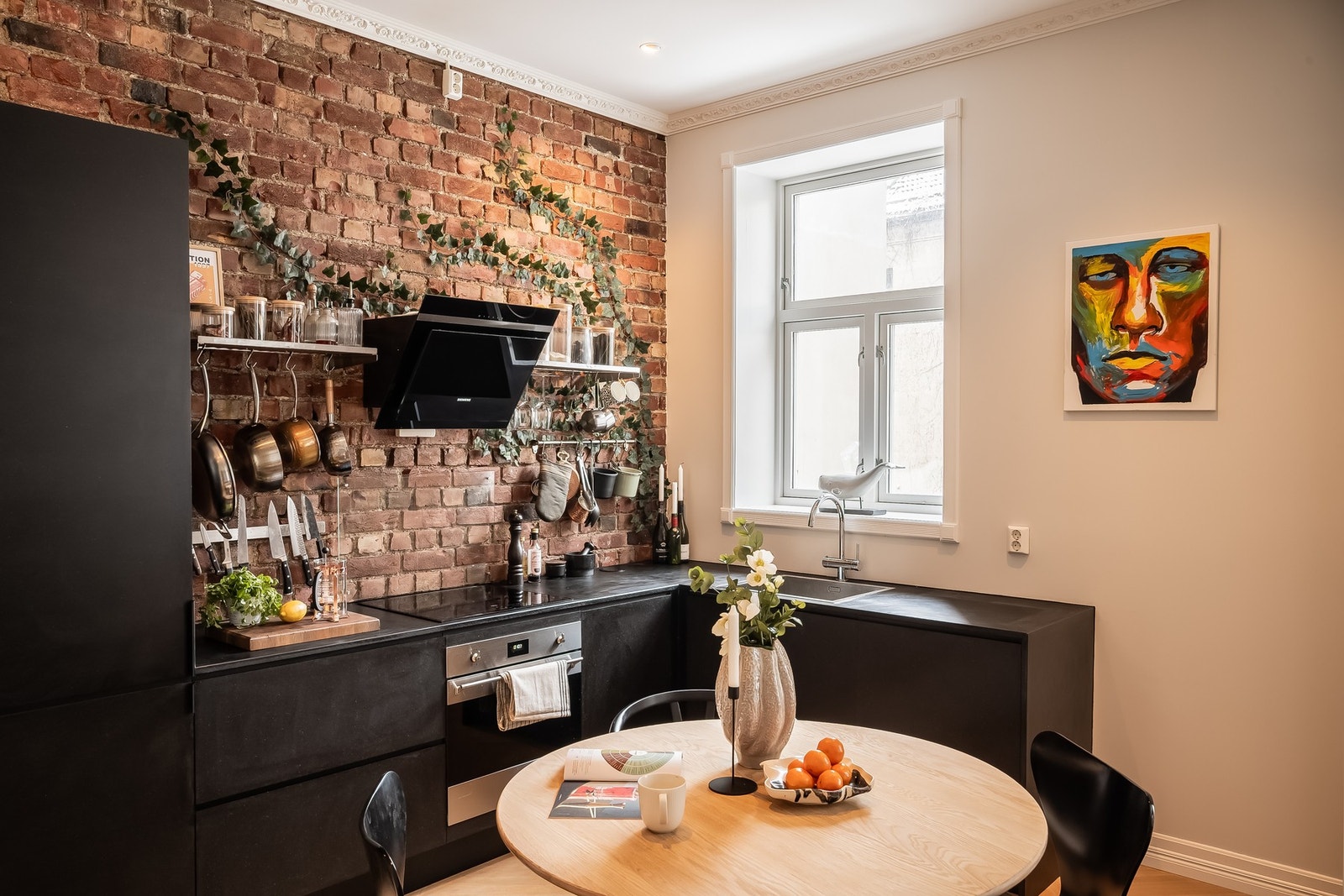 Kjøkkenet har en stilren innredning med glatte fronter og integrerte hvitevarer som koketopp, stekeovn, kombinert kjøle- og fryseskap samt oppvaskmaskin. Galleribilde