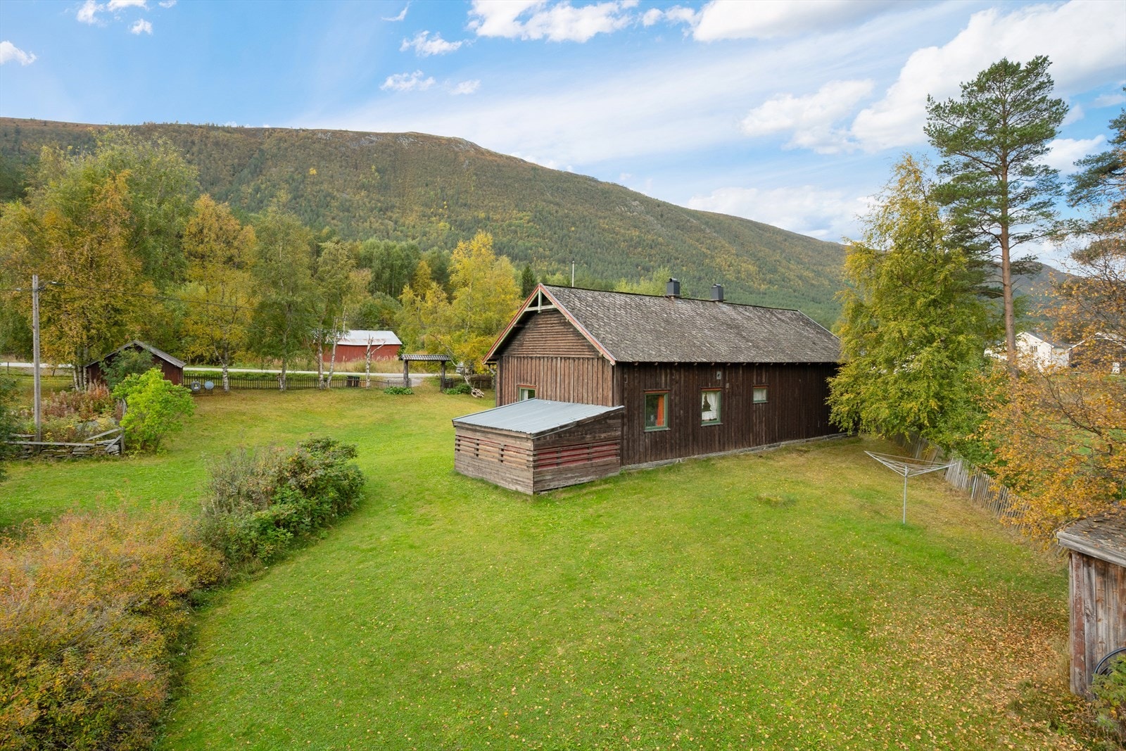 Eiendommen har flaggstang og tomten er gjerdet inn. Galleribilde