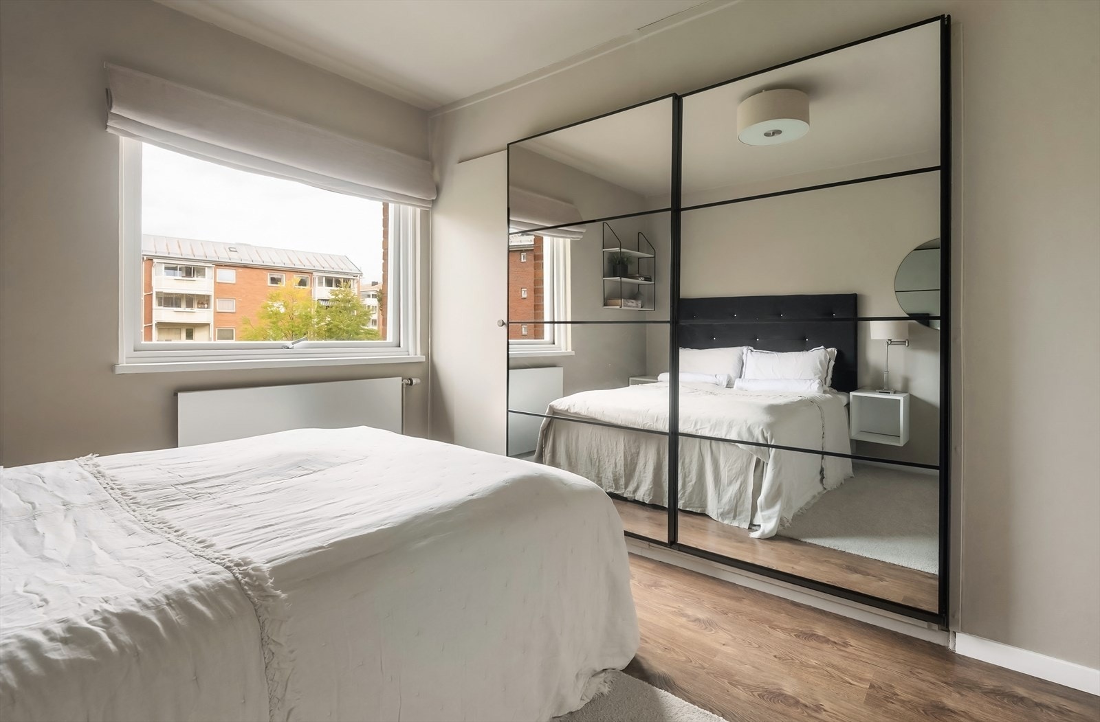 En stor skyvedørsgarderobe med speilfronter gir rikelig med oppbevaringsplass. Galleribilde