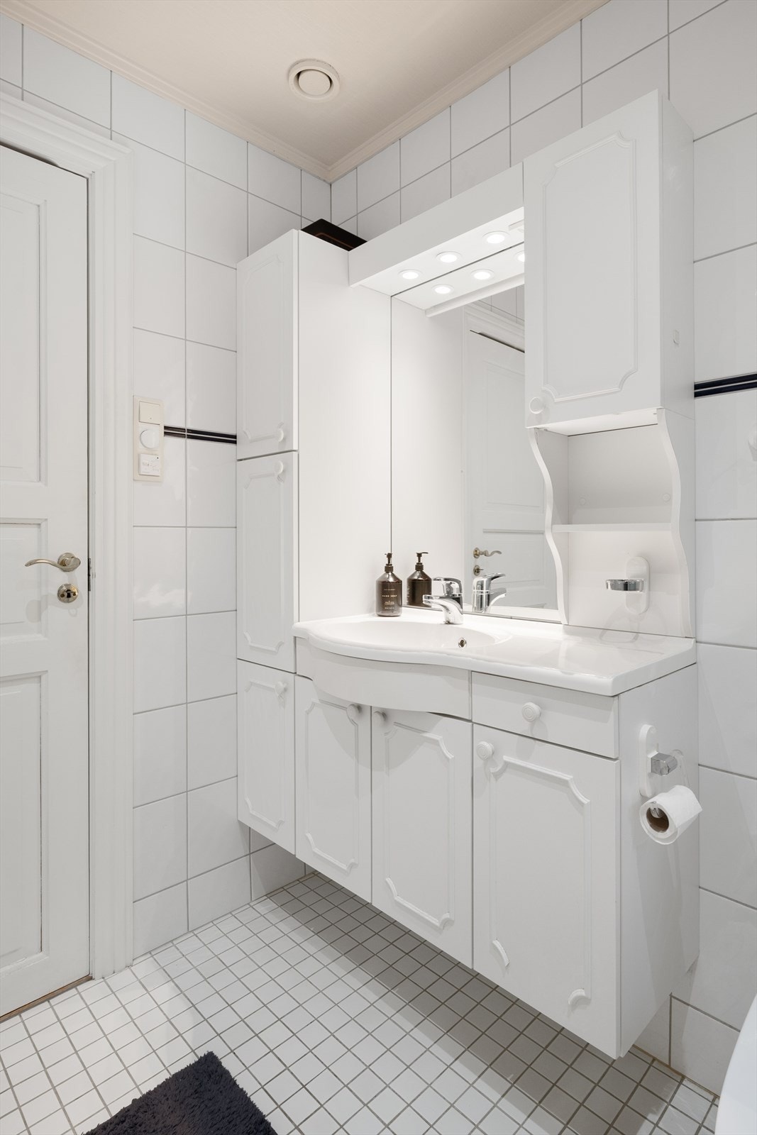 Den lyse innredningen har profilerte fronter og heldekkende, buet servant. Galleribilde