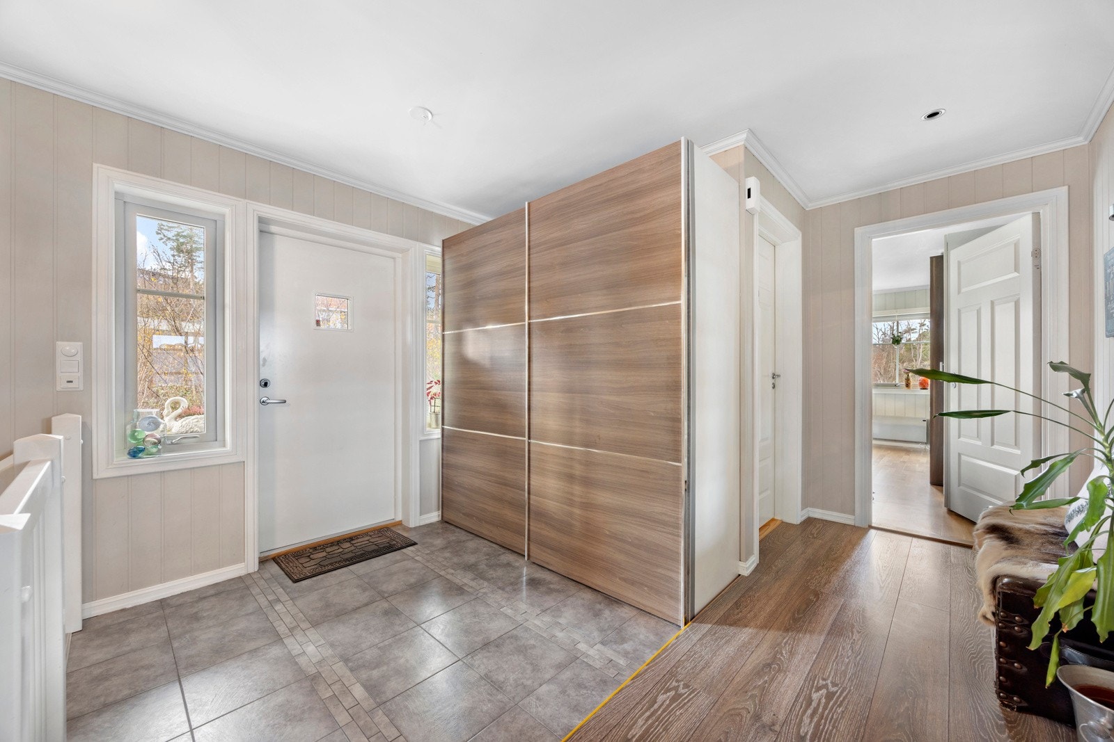 Inngangspartiet ønsker deg velkommen med en romslig hall med flislagt gulv, varmekabler og delikate overflater. Galleribilde