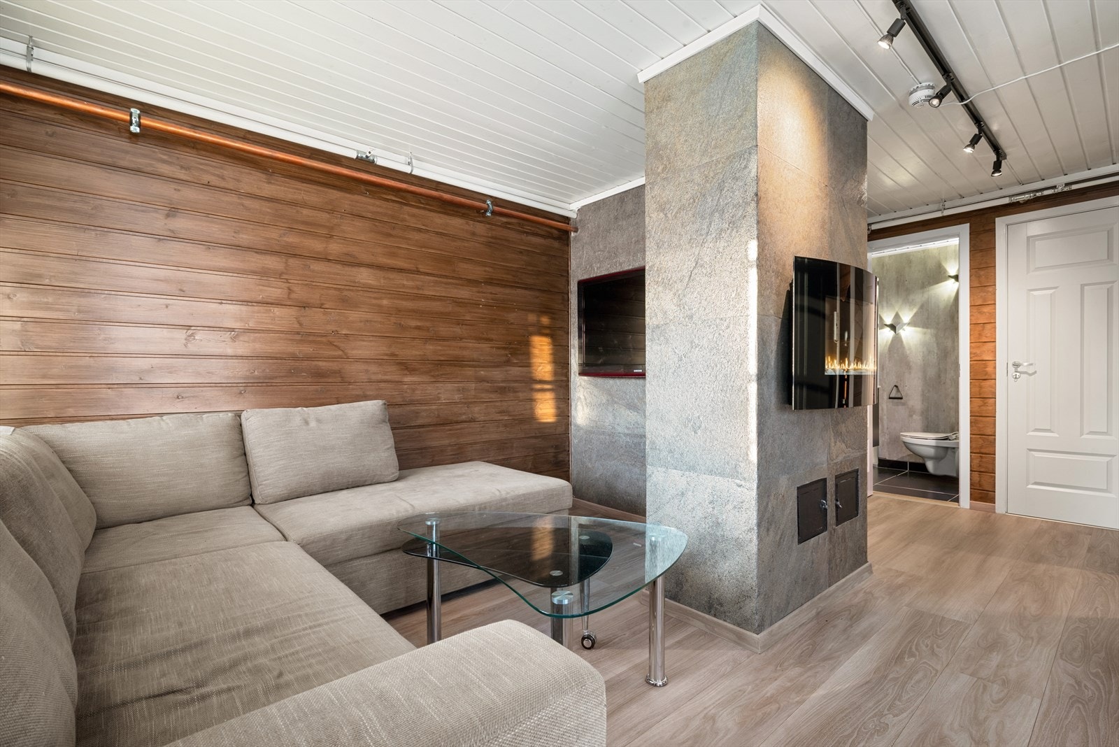 I allrommet er det en kombinasjon av skifer og lasert panel på veggene, og rommet har lyst, enstavs laminatgulv. Galleribilde