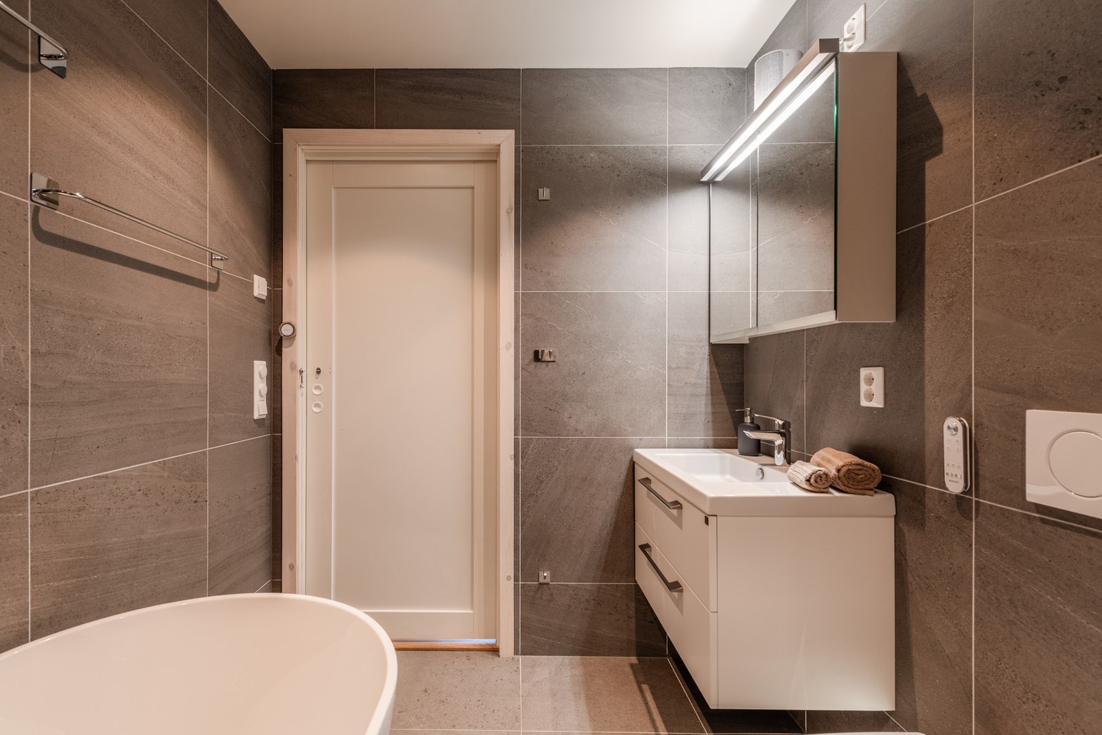 Badet har badekar, dusjkabinett og dusjtoalett Galleribilde