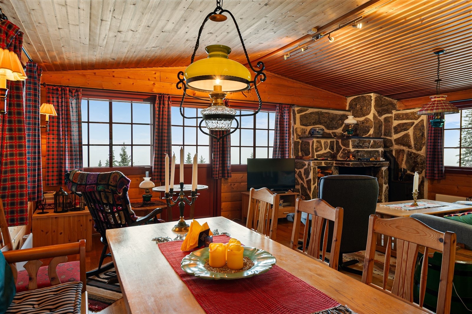 Spisestuen har utsyn mot grøntområdet, med panelvegger som gir en tradisjonell hyttefølelse. Galleribilde