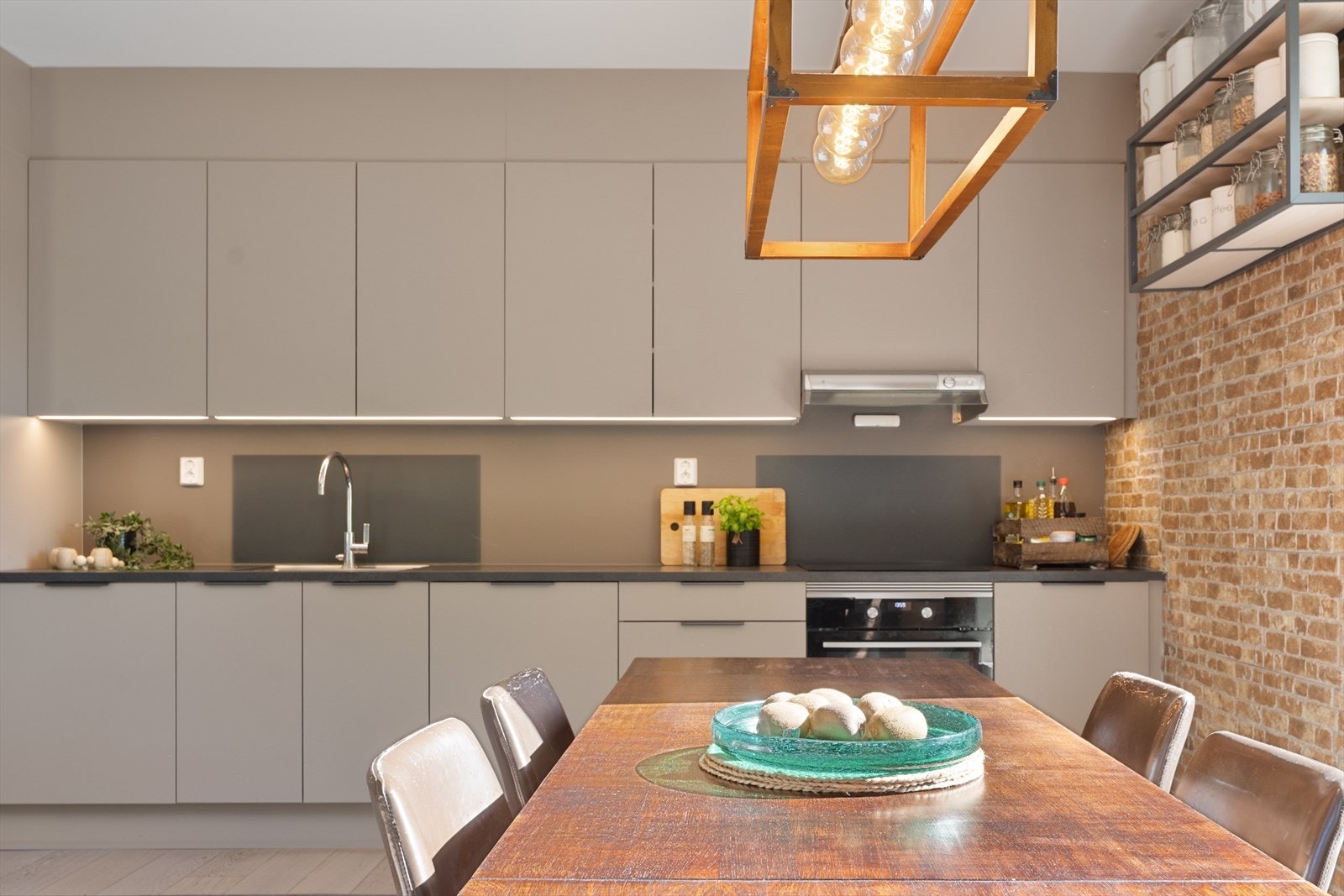 Stort og praktisk kjøkken som er designet med tanke på funksjonalitet og har godt med skap- og benkeplass Galleribilde