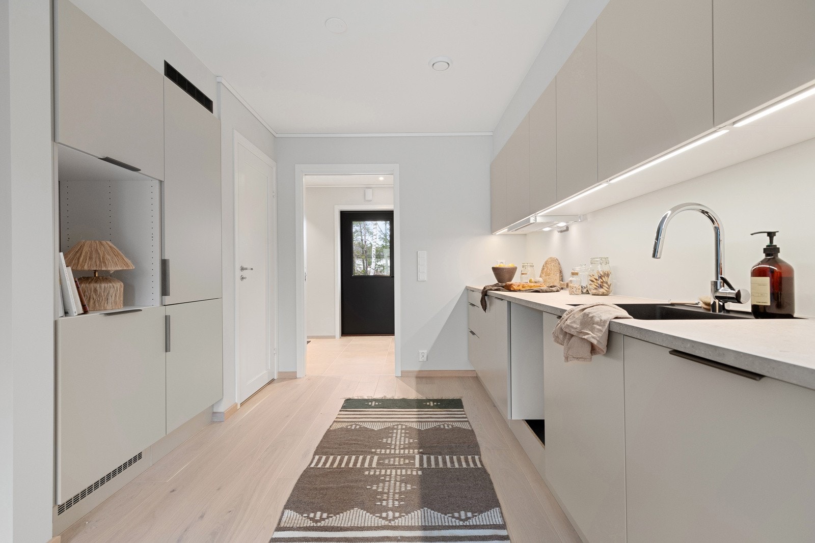 Kjøkkenet er gjennomtenkt utformet med fokus på funksjonalitet, og byr på rikelig med skap- og benkeplass. Bildene i annonsen er fra annen bolig i prosjektet. Det er avvik mellom bildene og boligen som selges. Galleribilde