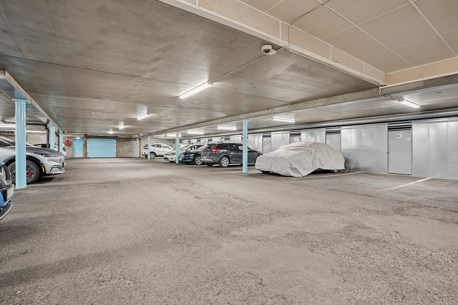 Fast parkeringsplass i felles garasjekjeller med bod i bakkant. Medfølgende plass er merket 36P og det er installert elbillader Galleribilde