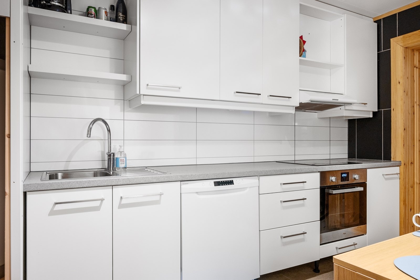 Lyst, pent kjøkken med integrert platetopp og komfyr, samt oppvaskmaskin. Galleribilde