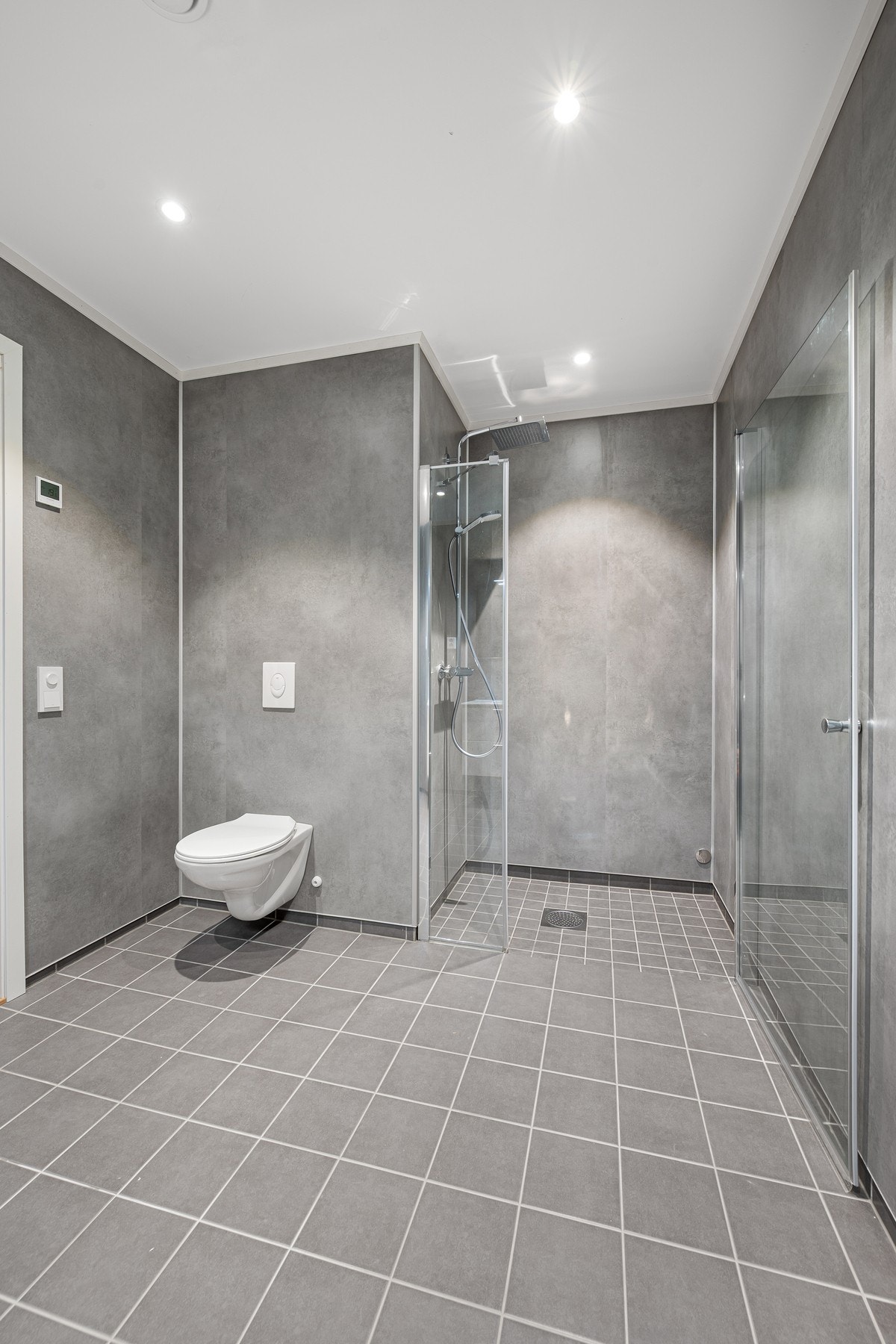 Baderommet er innredet med dusjnisje, servant og vegghengt toalett Galleribilde