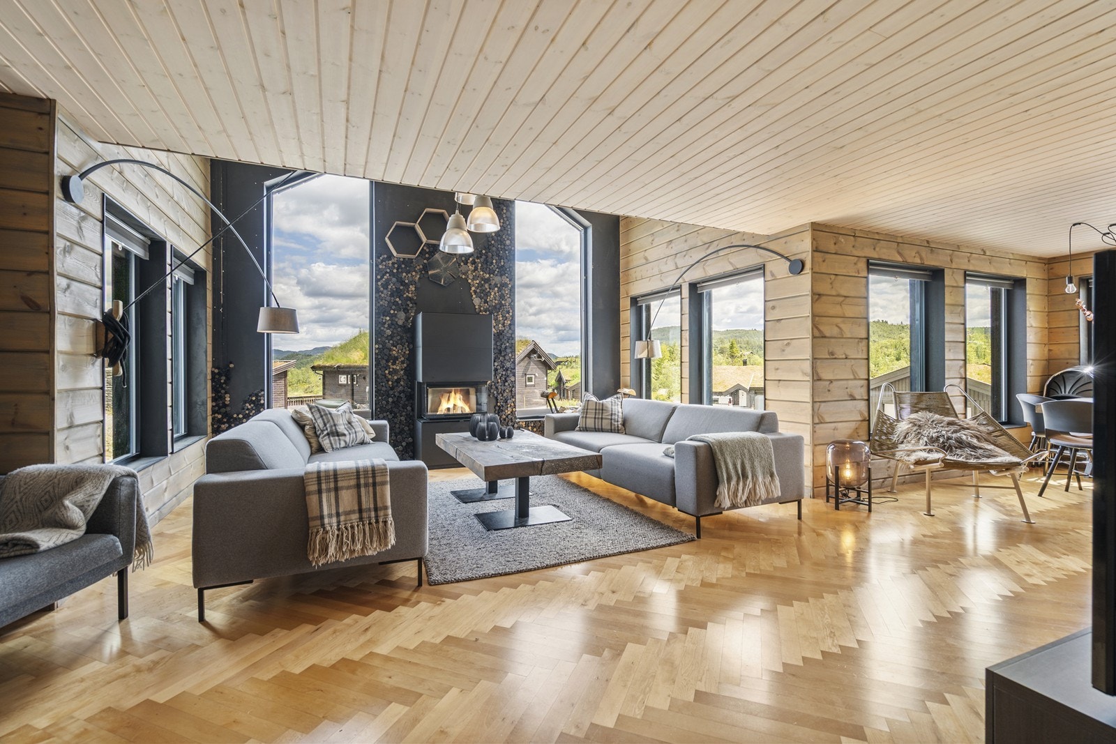 Lys, åpen stue med ekstra takhøyde og store vinduer som gir en imponerende romfølelse. Galleribilde