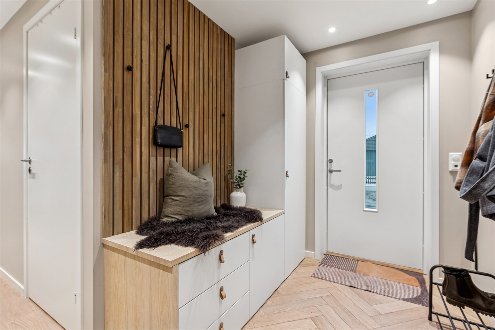 Man ønskes velkommen i en innbydende entré med god plass til å henge fra seg yttertøy. Galleribilde