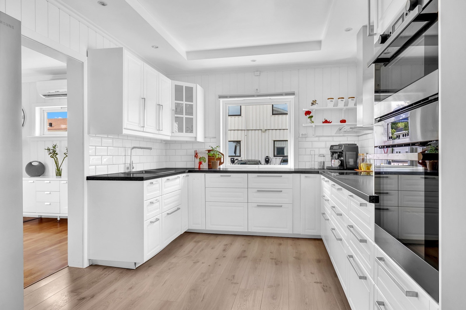 Moderne kjøkken fra 2010 med hvite fronter, god benkeplass og integrerte hvitevare Galleribilde