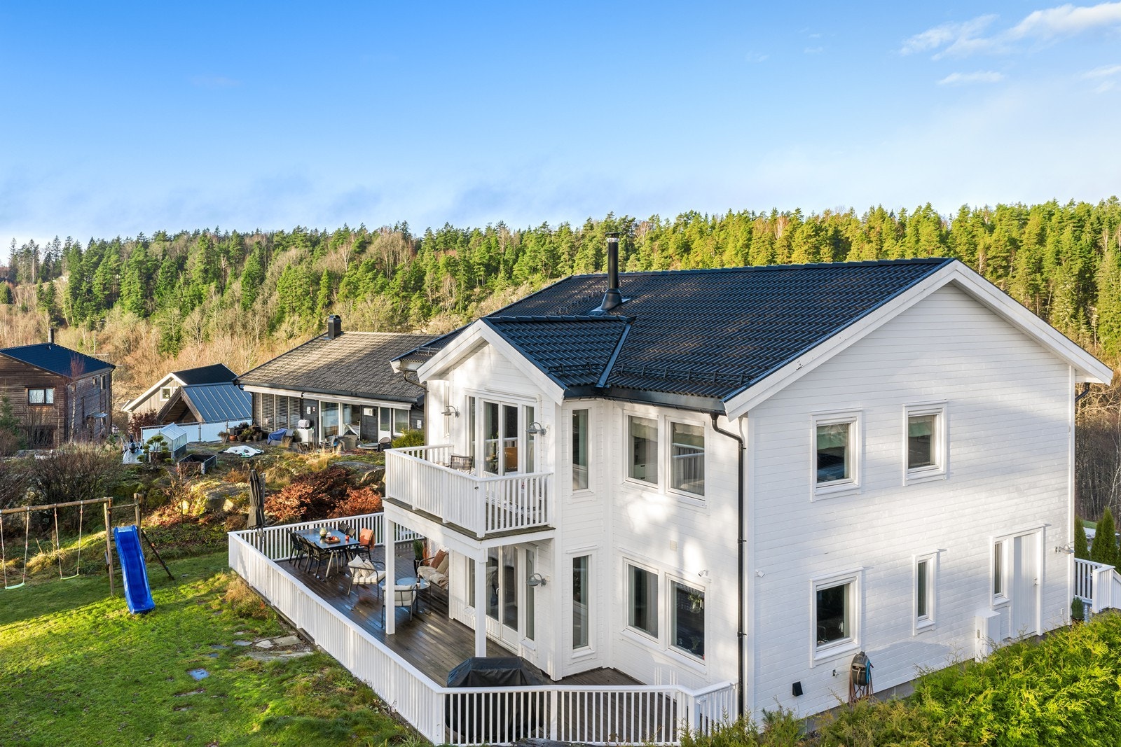 Fra hagen har man god oversikt over terrassen og balkongen i andre etasje Galleribilde